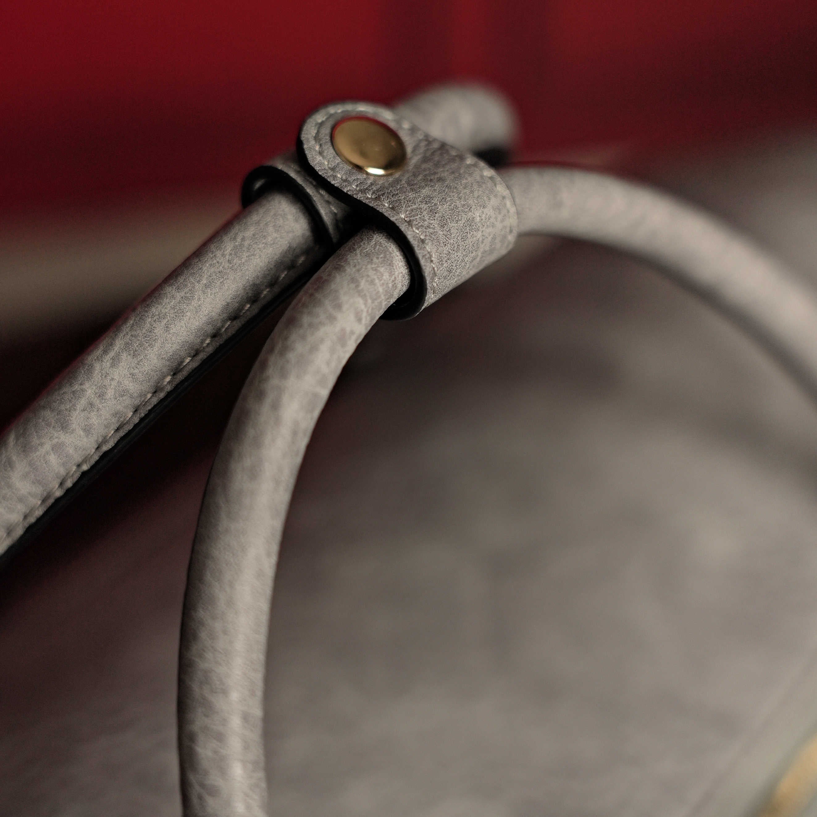 Close-up of a gray cable with a metal connector on a blurred background