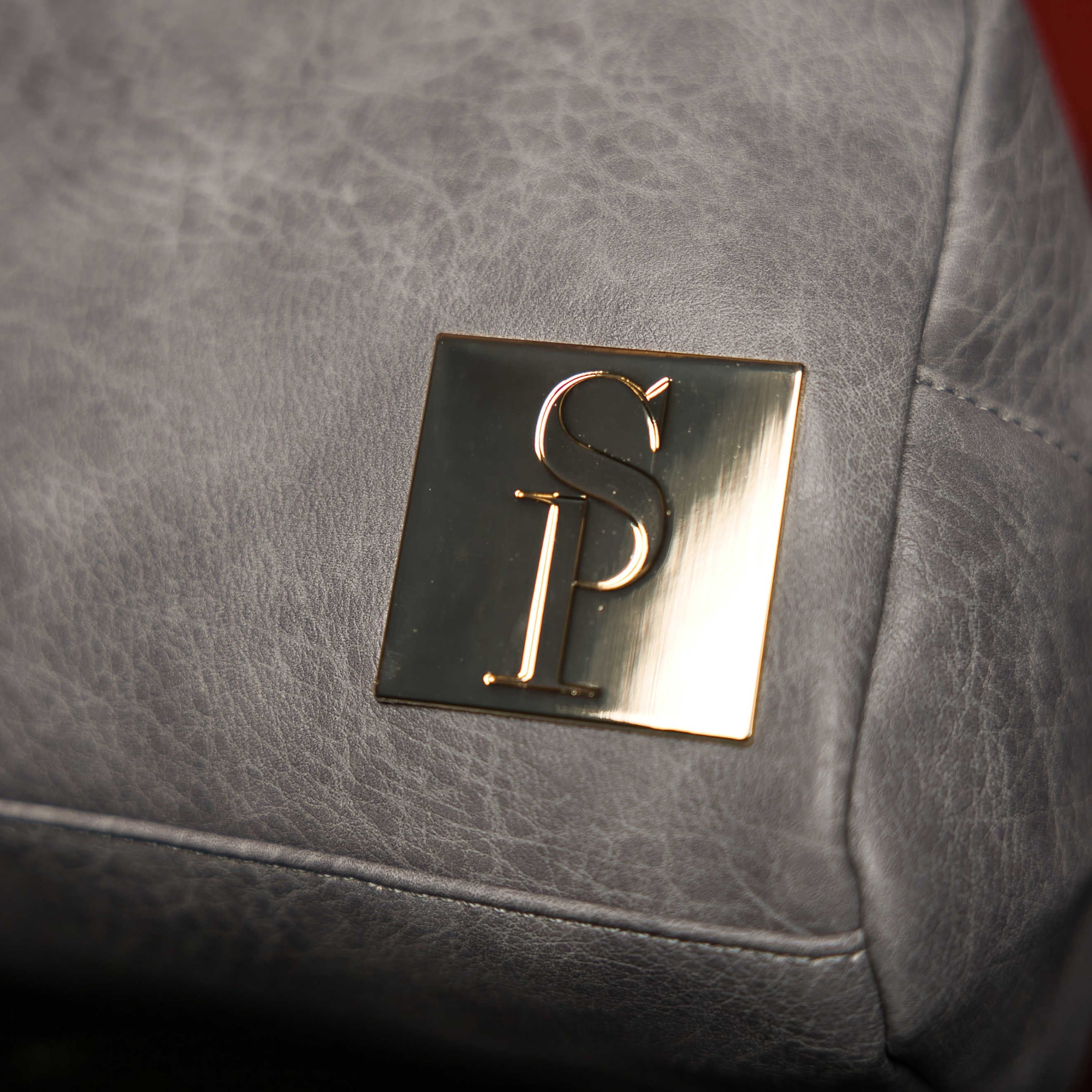 Gold logo on a gray leather surface