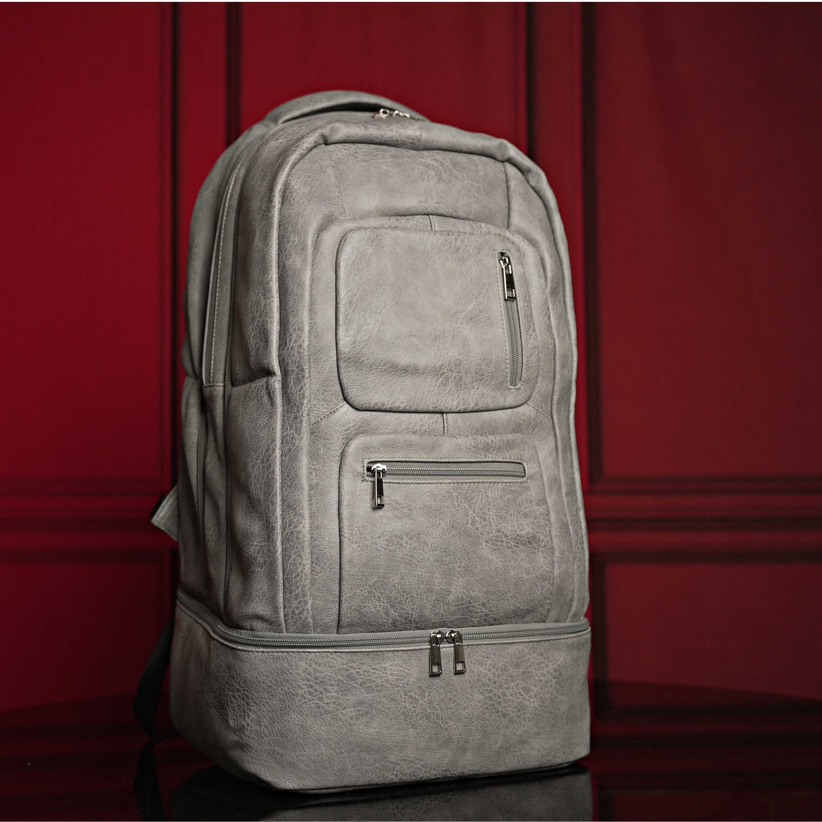 Gray backpack on a red background
