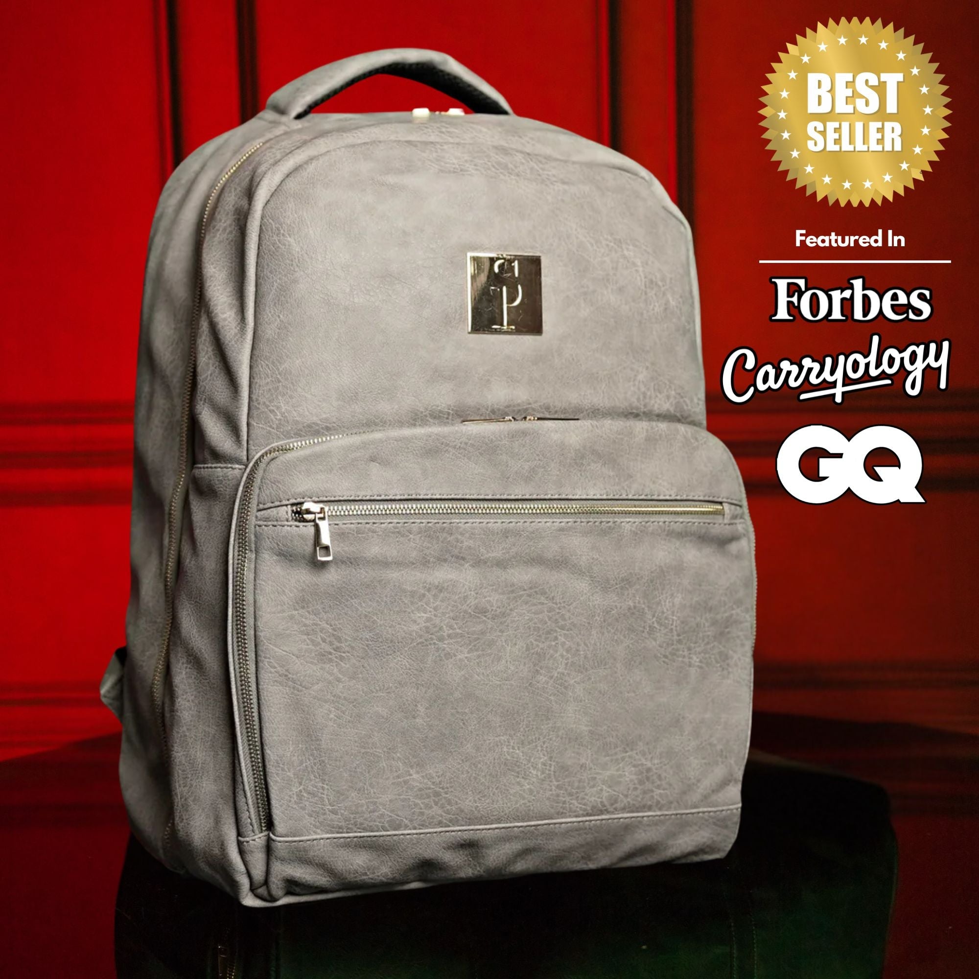 Gray backpack with a brand logo on a red background, featuring 'Forbes Carryology' and 'GQ'.