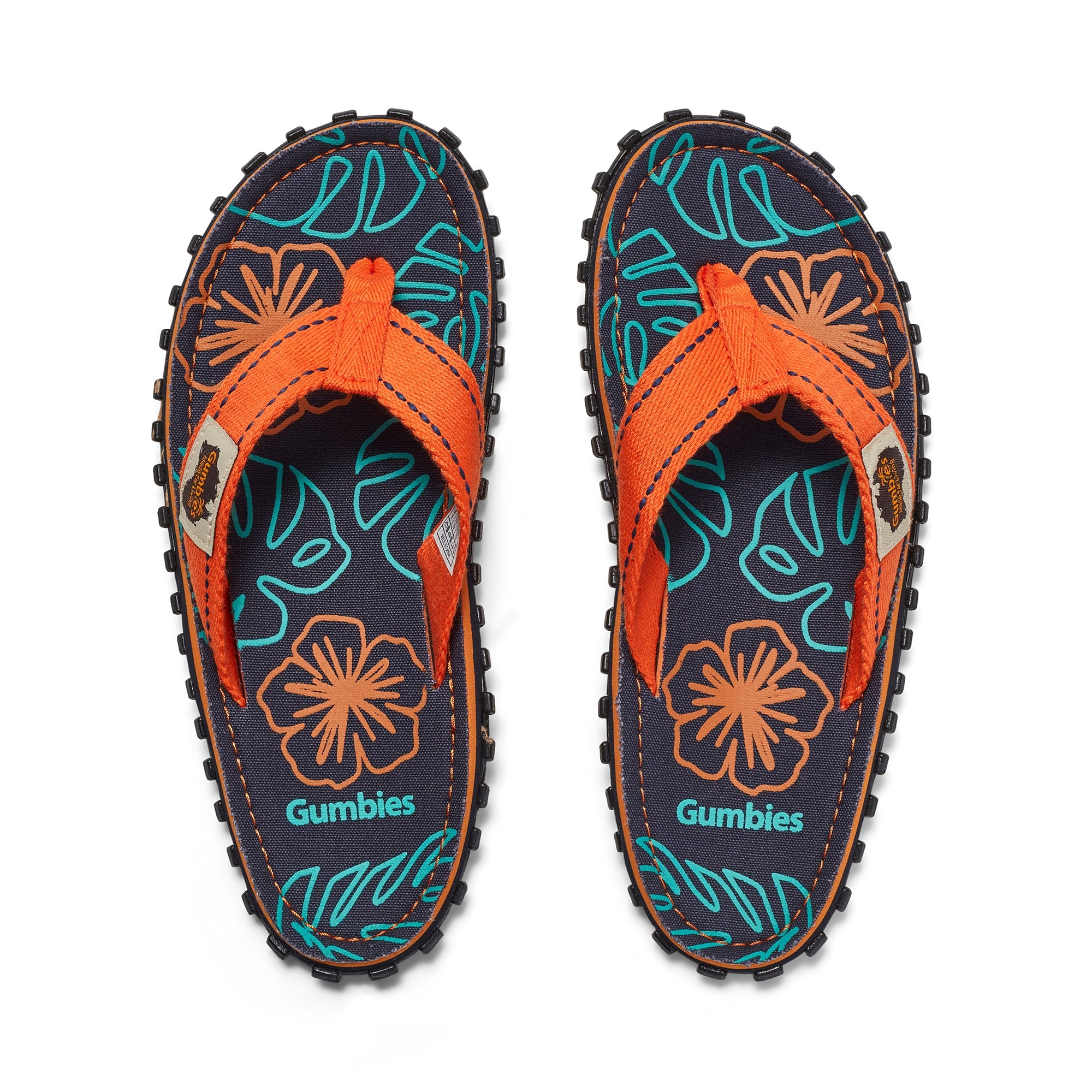 Pair of Gumbies sandals with floral design on a white background