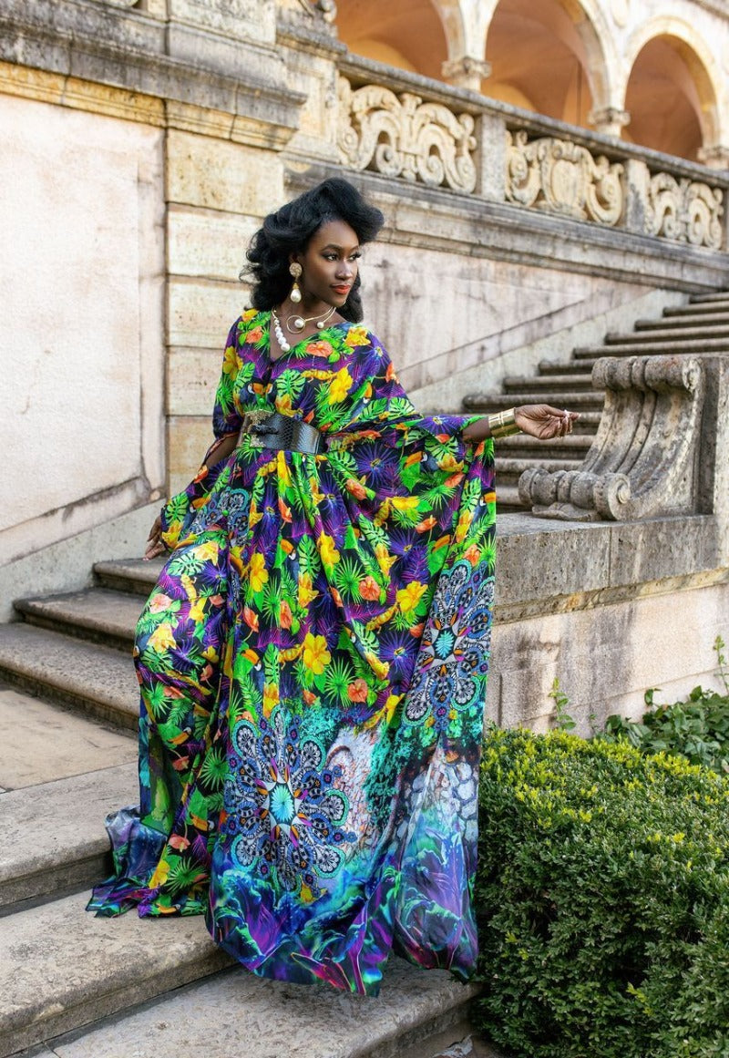 Woman in a colorful dress standing on stone steps with architectural background