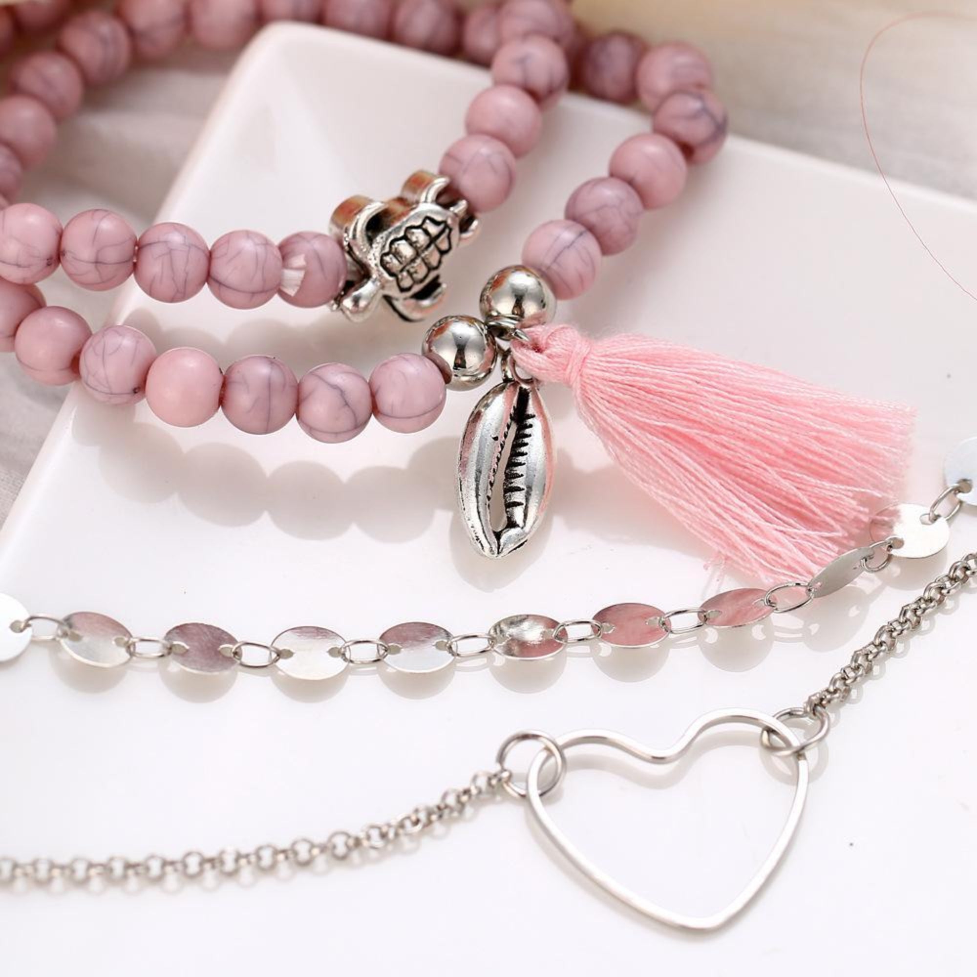 Four Piece Pink Tassel Bracelet Set