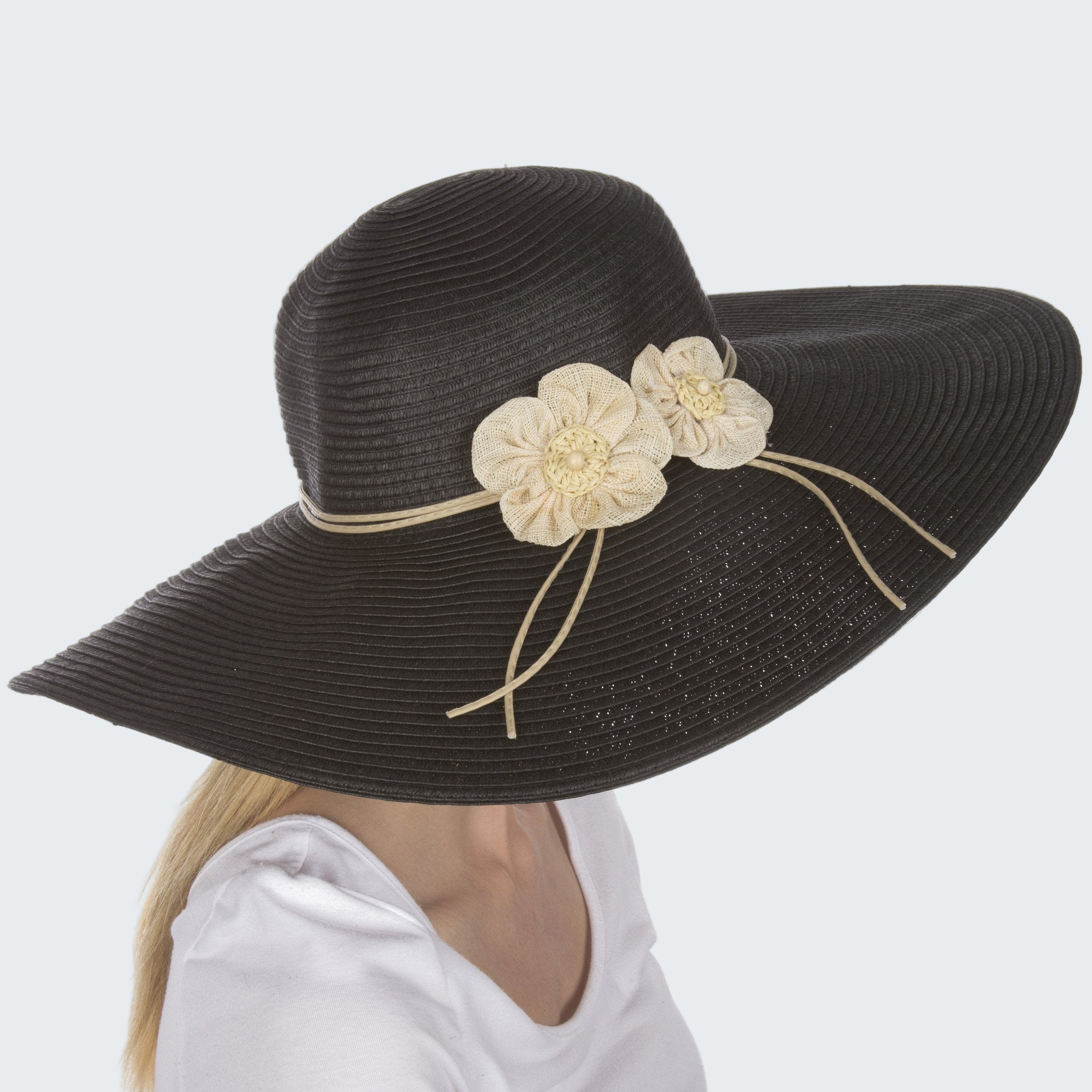 Black sun hat with beige flowers on a white background