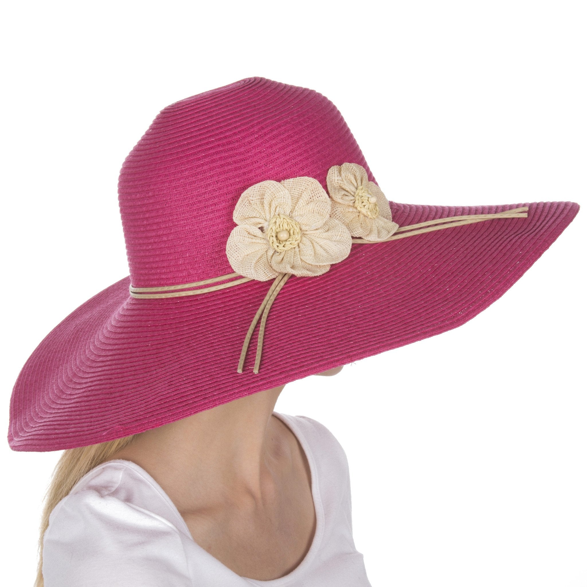 Pink sun hat with floral embellishments on a white background