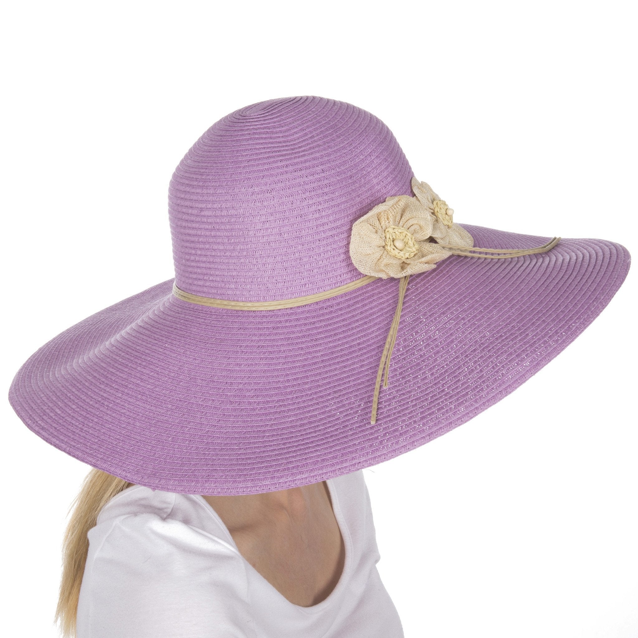Purple sun hat with a decorative flower on a white background