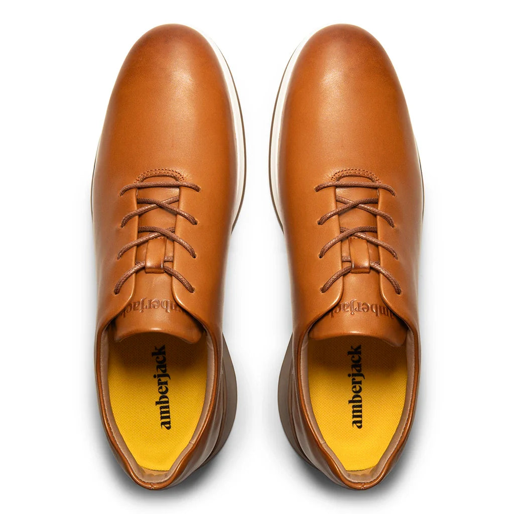 Pair of brown leather shoes with 'amberjack' branding on a white background