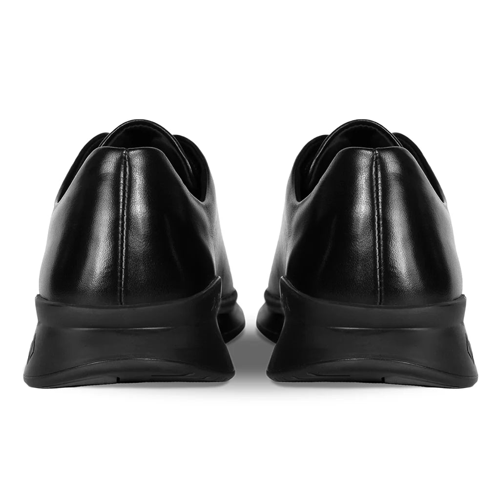 Black leather shoes with thick soles on a white background
