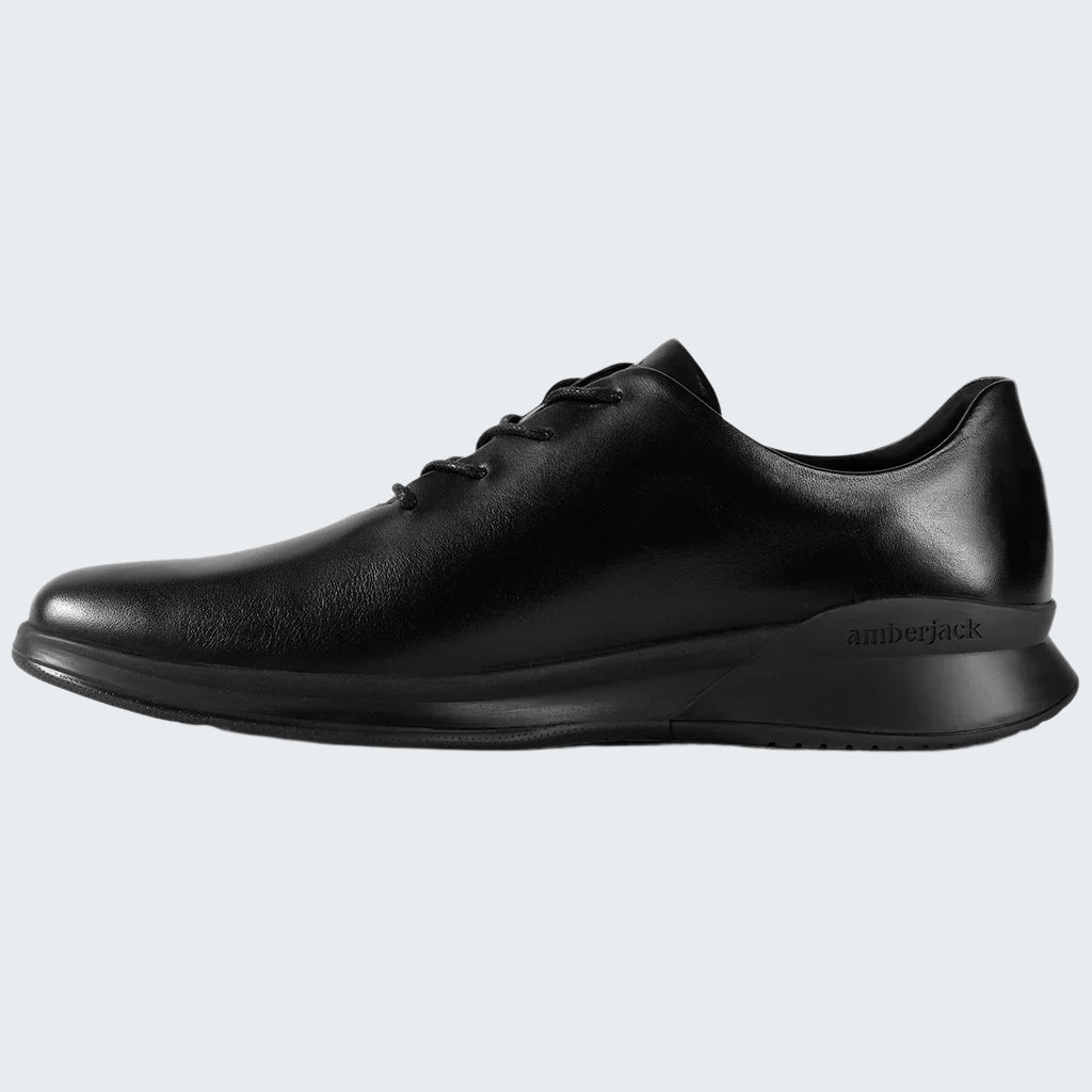 Black leather shoe on a white background