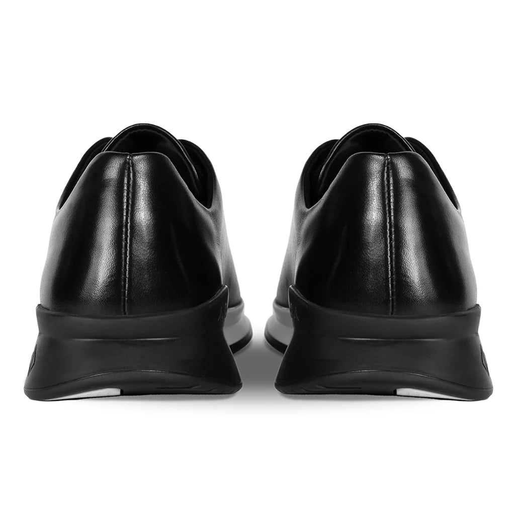 Black leather shoes shown from the back on a white background