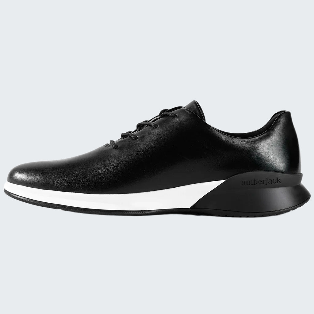 Black sneaker with white sole on a white background