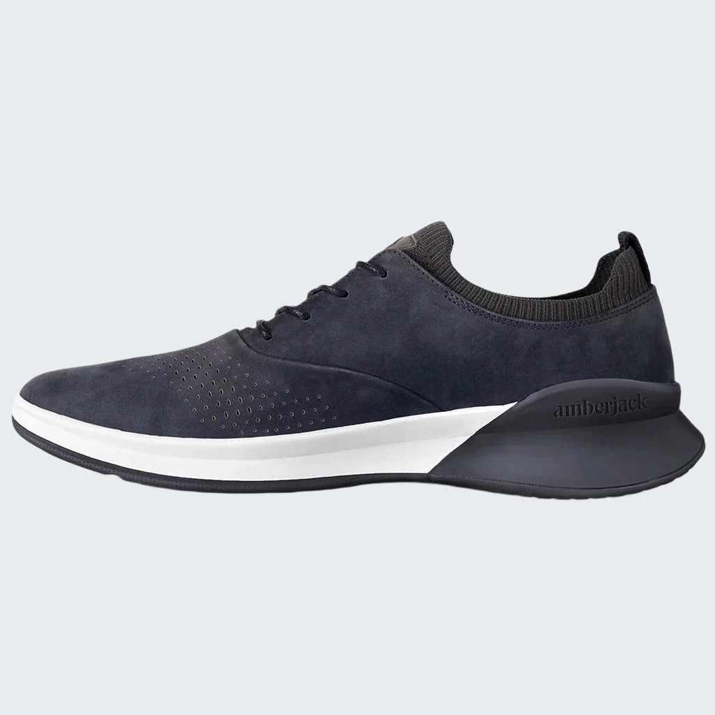 Navy blue athletic shoe with white sole on a white background