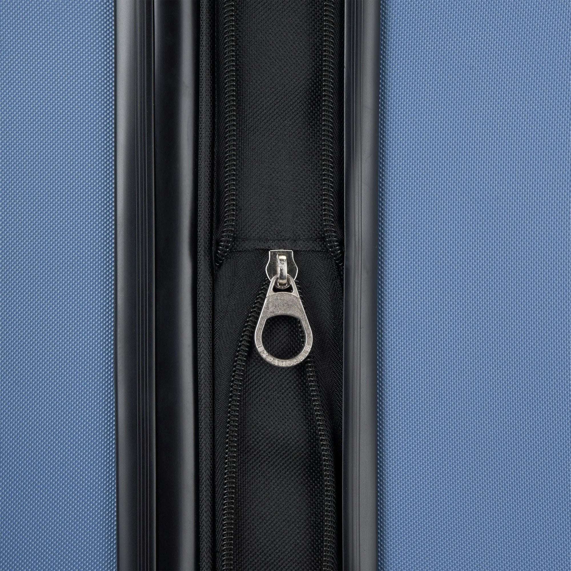 Close-up of a blue suitcase with a zipper and metal pull