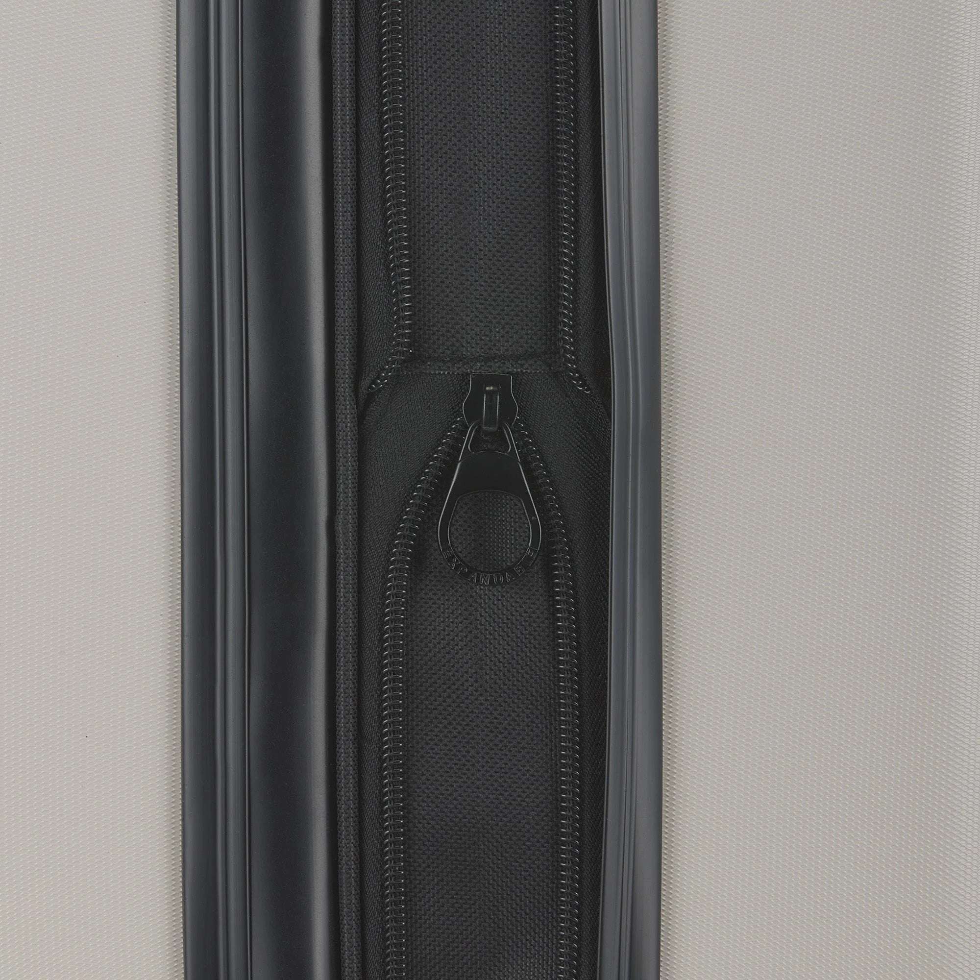 Close-up of a zipper on a suitcase with a neutral background