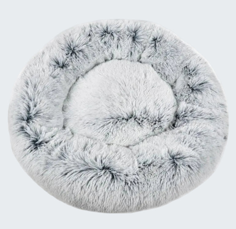 Round, fluffy pet bed on a white background