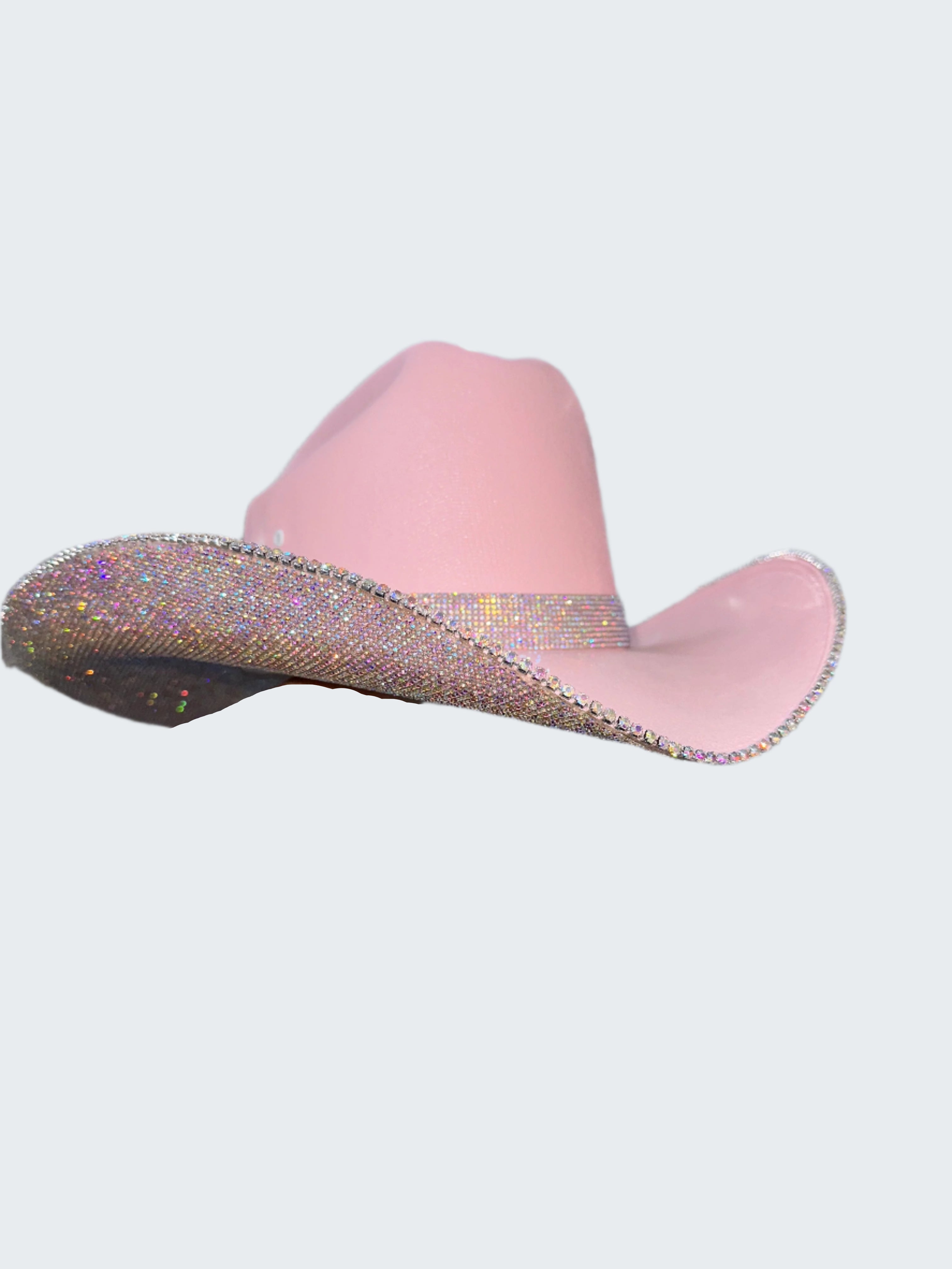 Pink slipper with glittery trim held against a sequin background