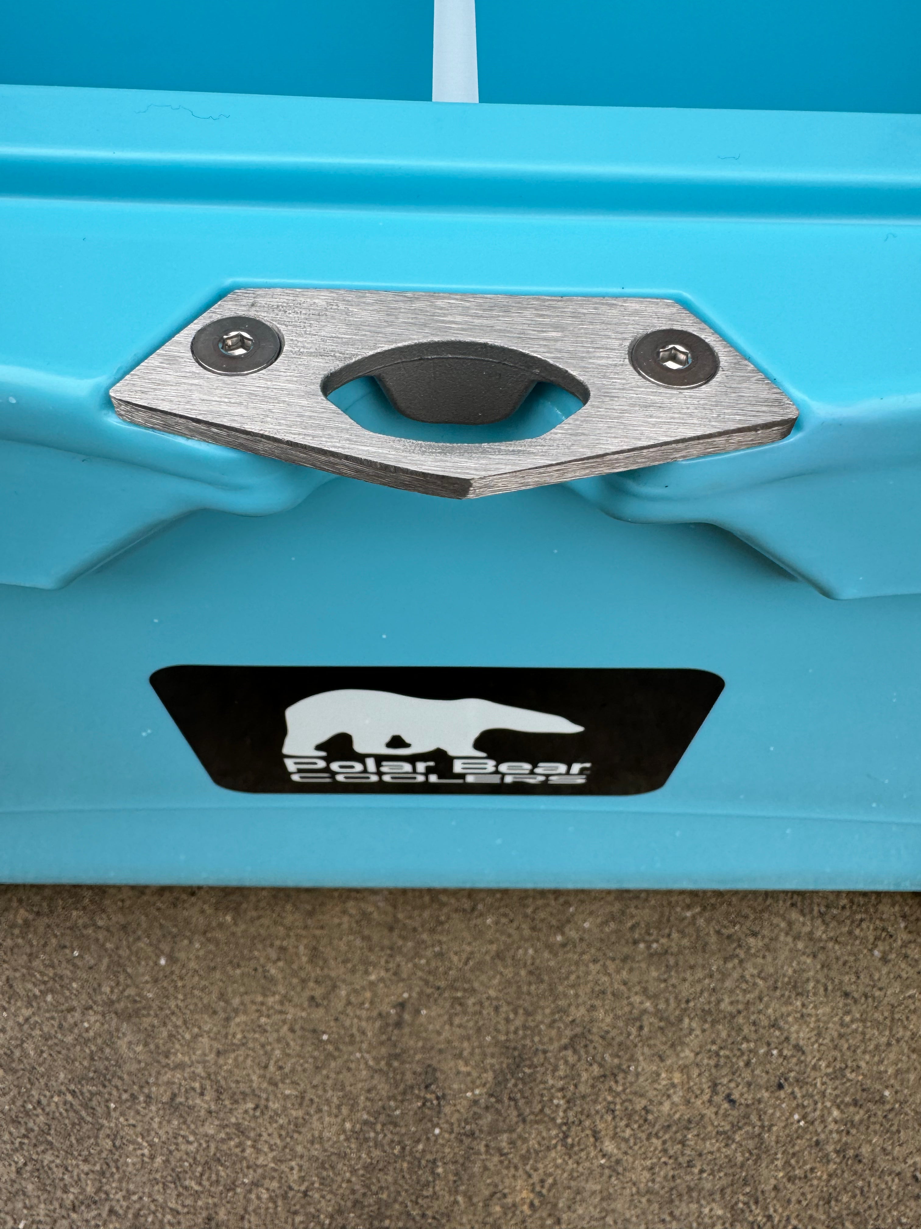 Close-up of a blue container with a metal handle and Polar Bear Coolers logo.