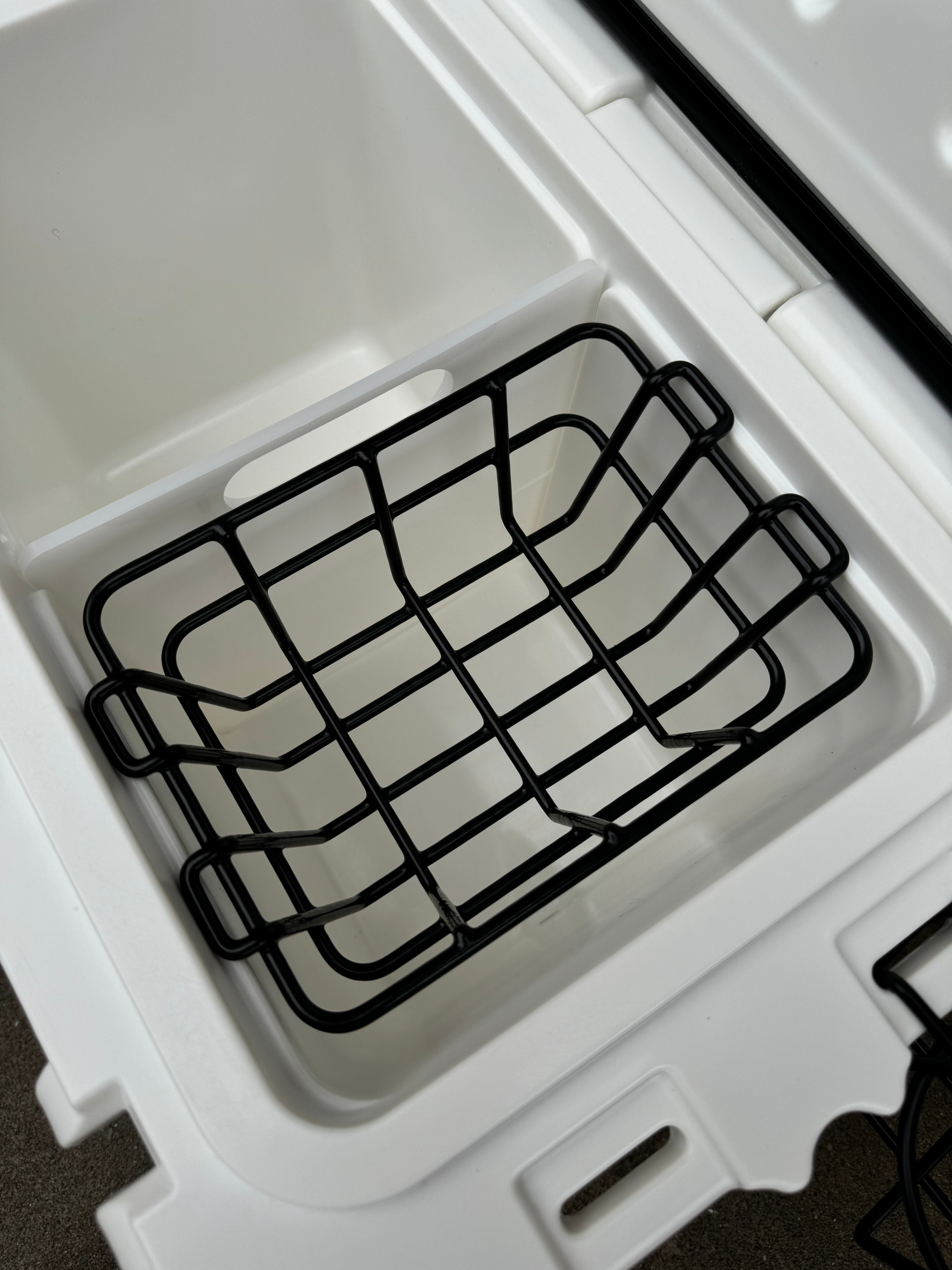 Black wire rack inside a white plastic container