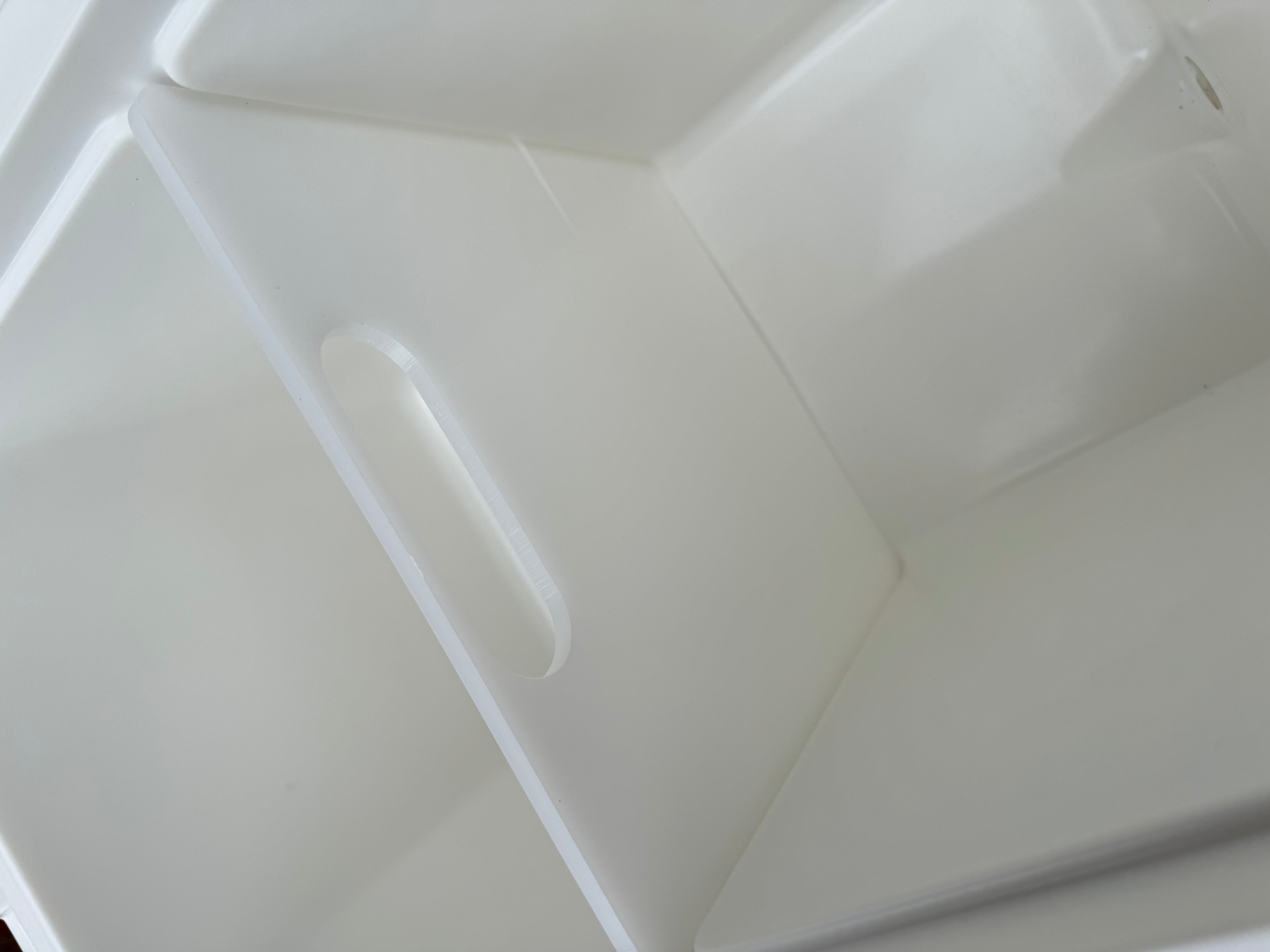 Close-up of a white plastic component with a textured surface