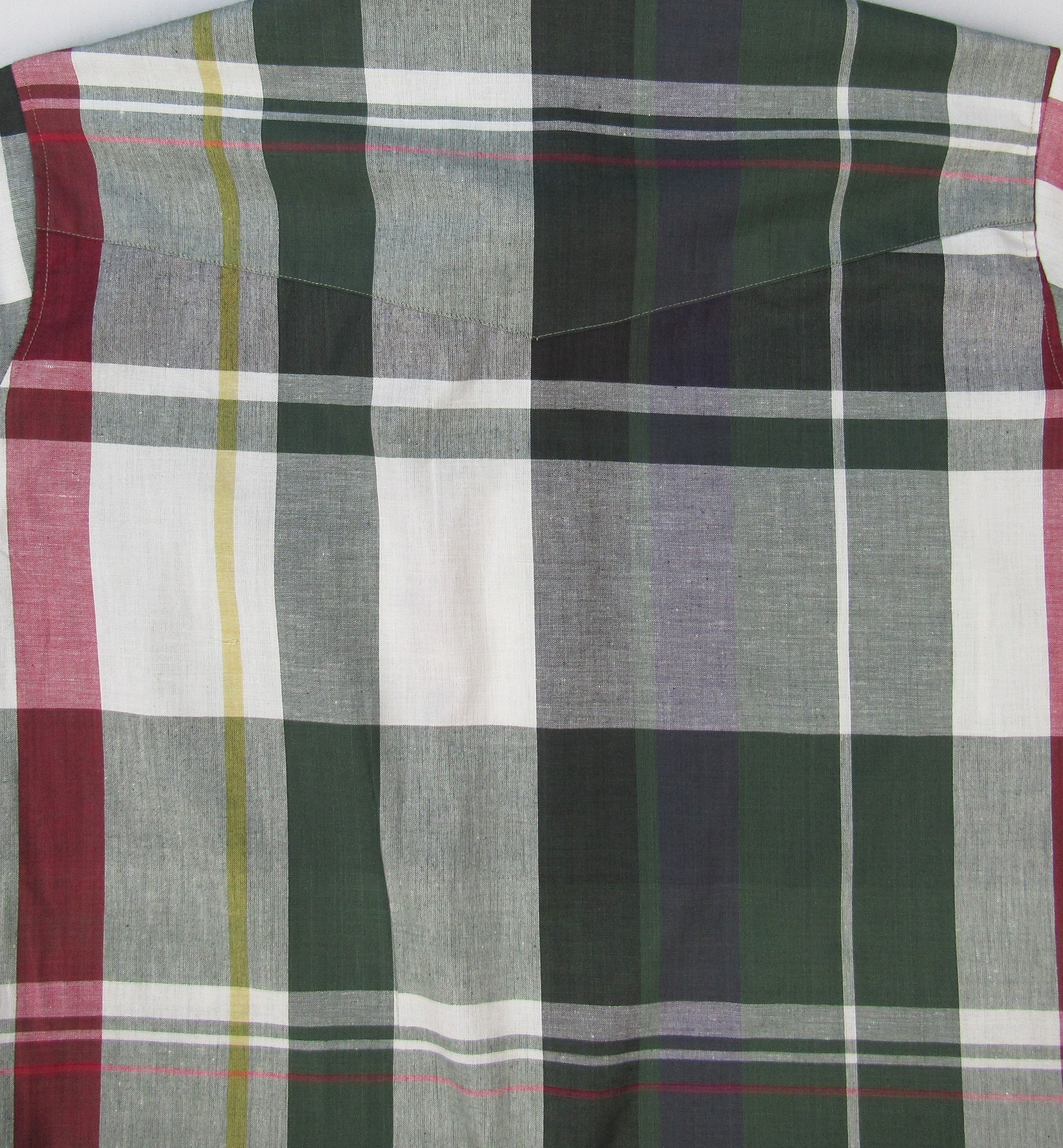 Plaid fabric with green, red, white, and gray colors.