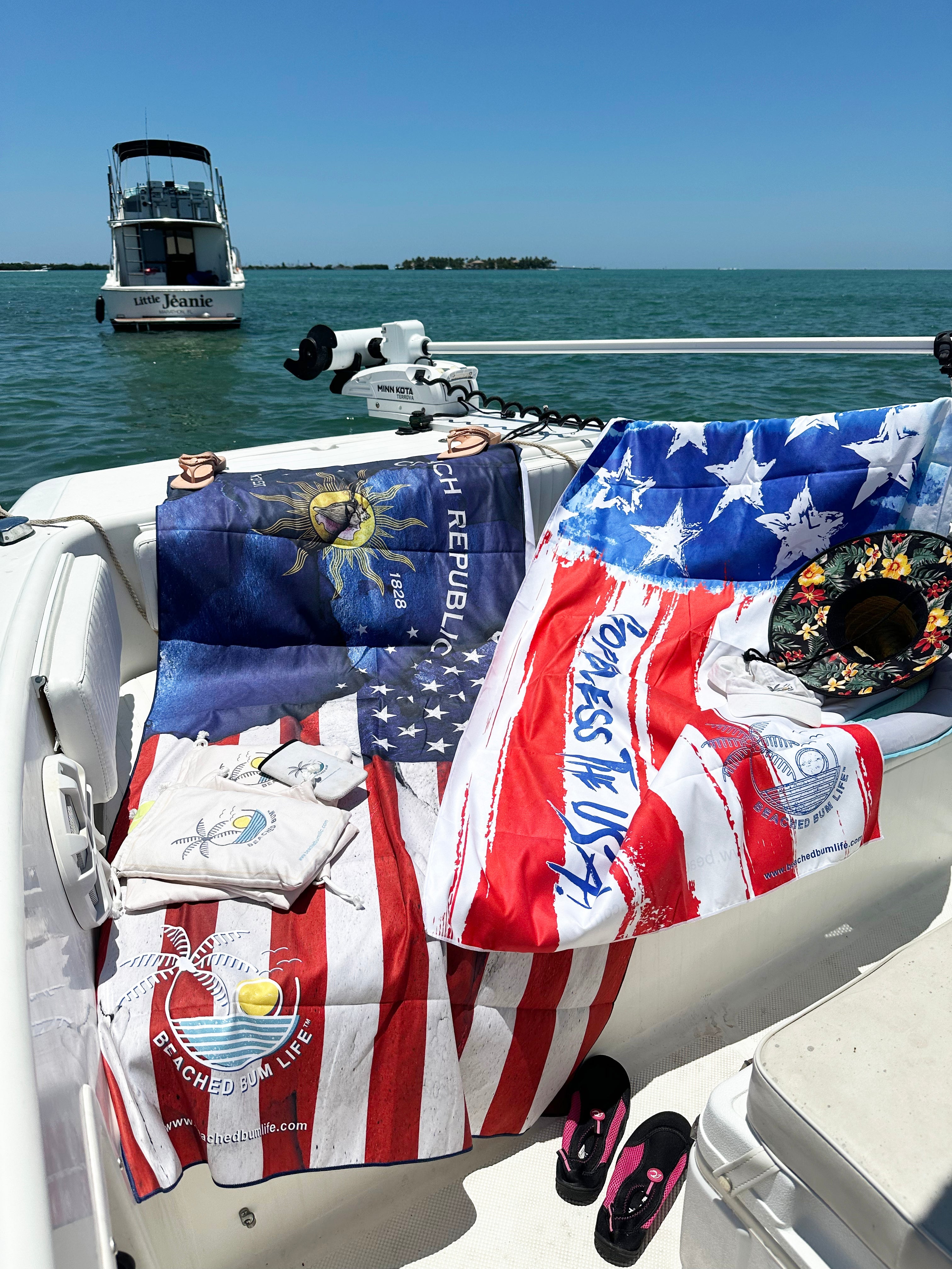Boat with various flags and items on a sunny day at sea