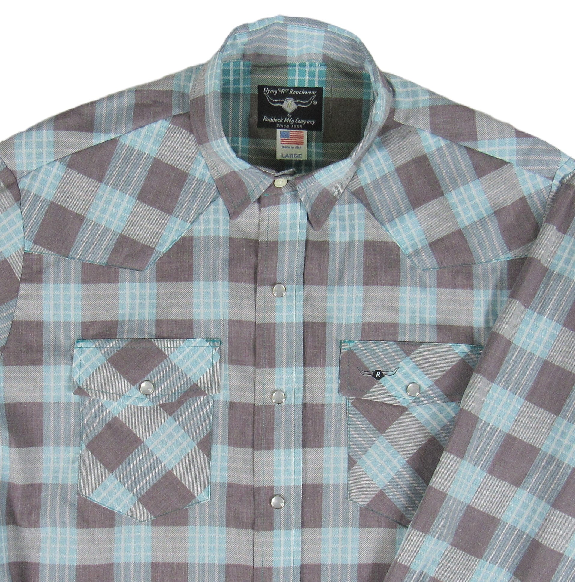 Plaid shirt with a visible brand label on a white background