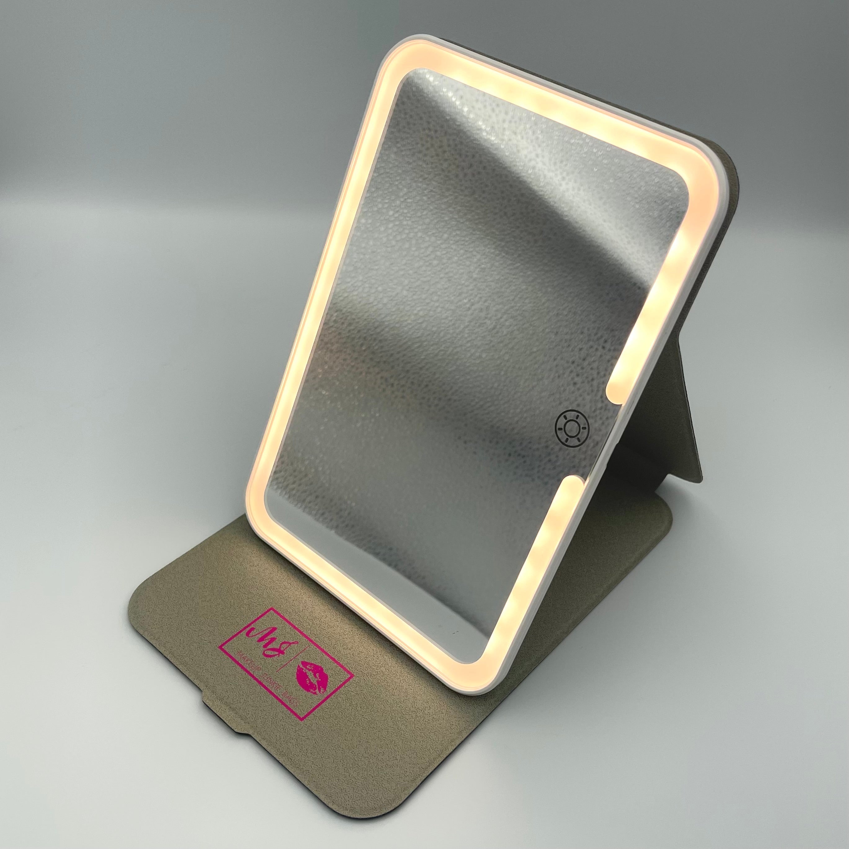 Portable makeup mirror with LED lights on a gray background
