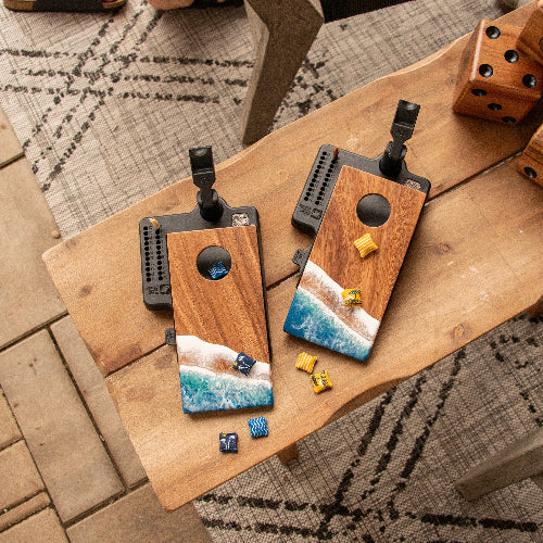 Wooden phone cases with ocean design on a wooden surface