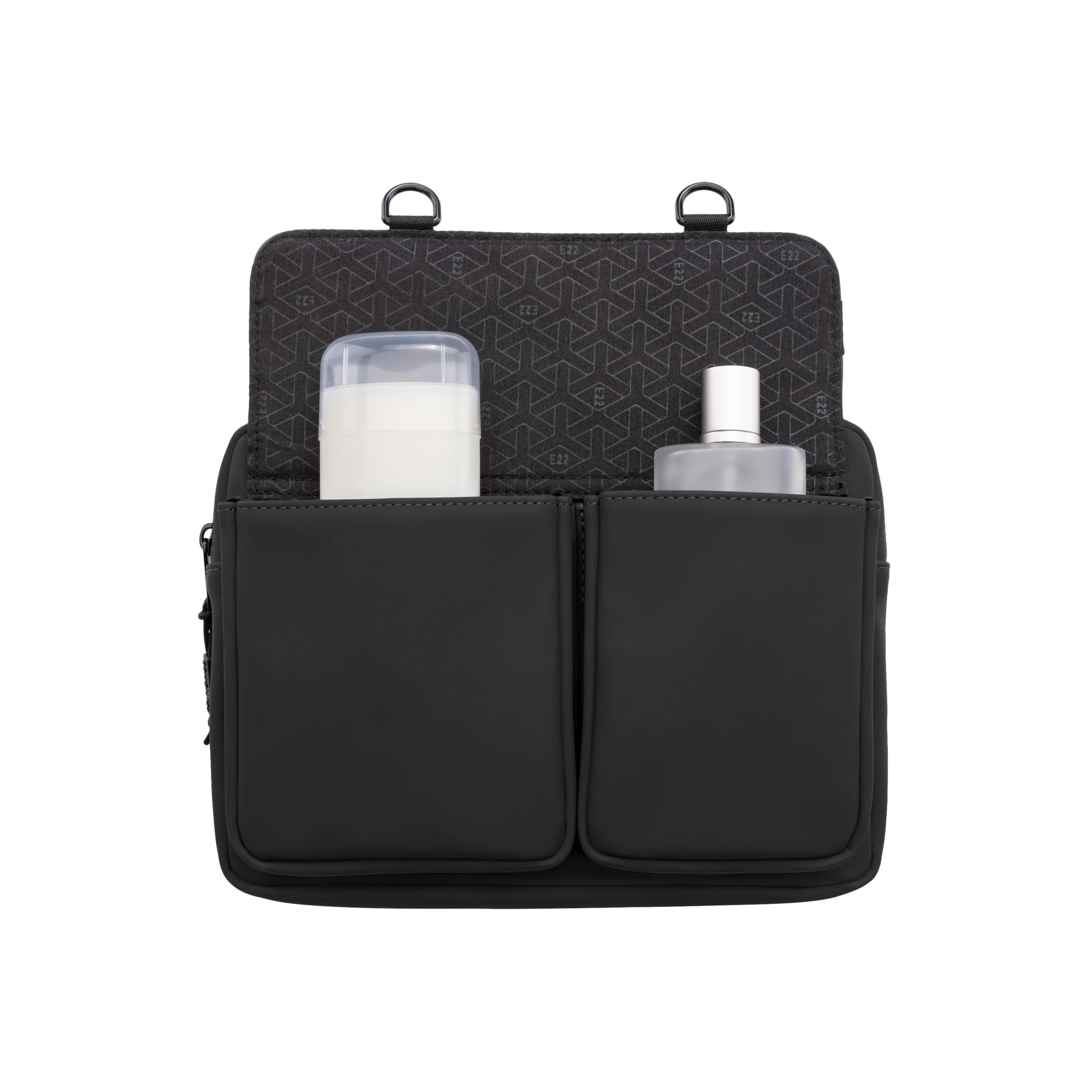 Black travel organizer with compartments containing a bottle and a container on a white background