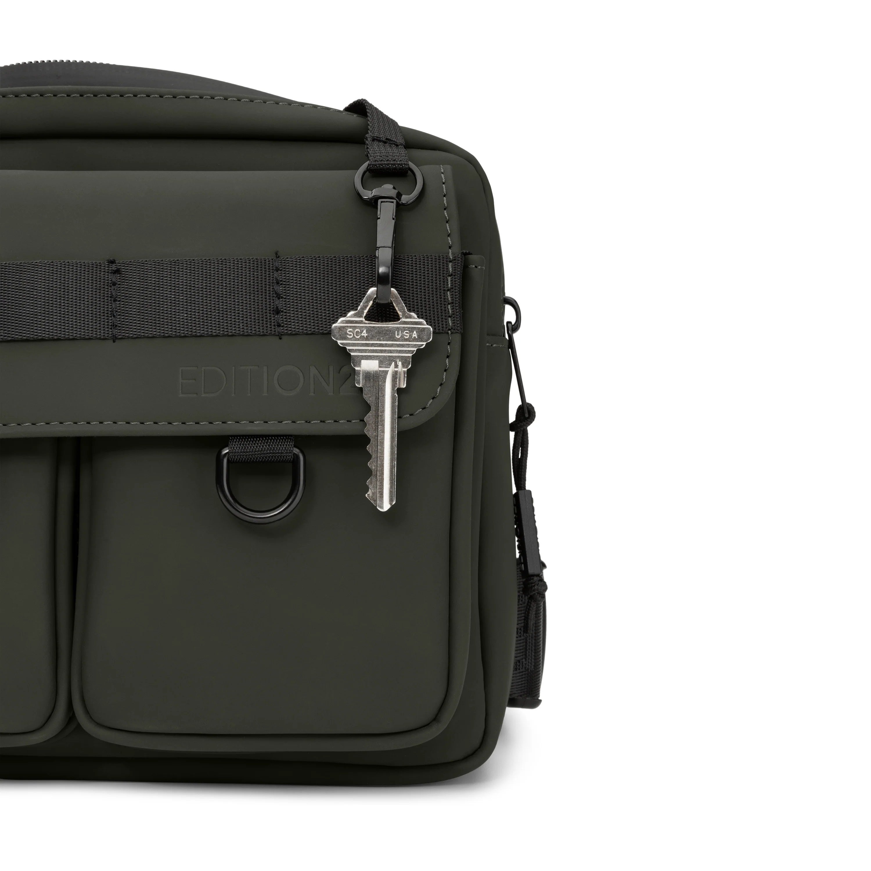 Black bag with a key attached on a white background