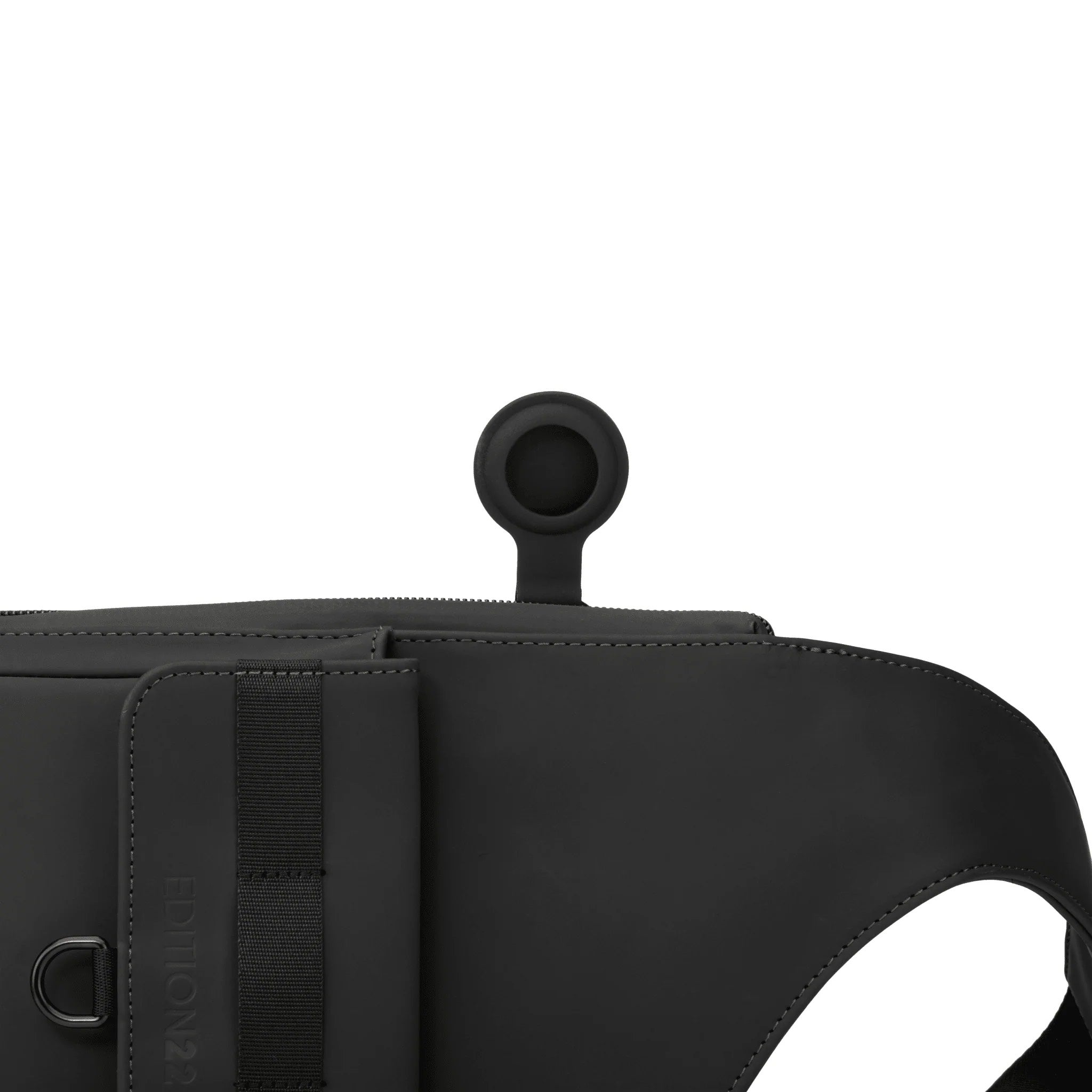 Black bag with a strap and circular handle on a white background