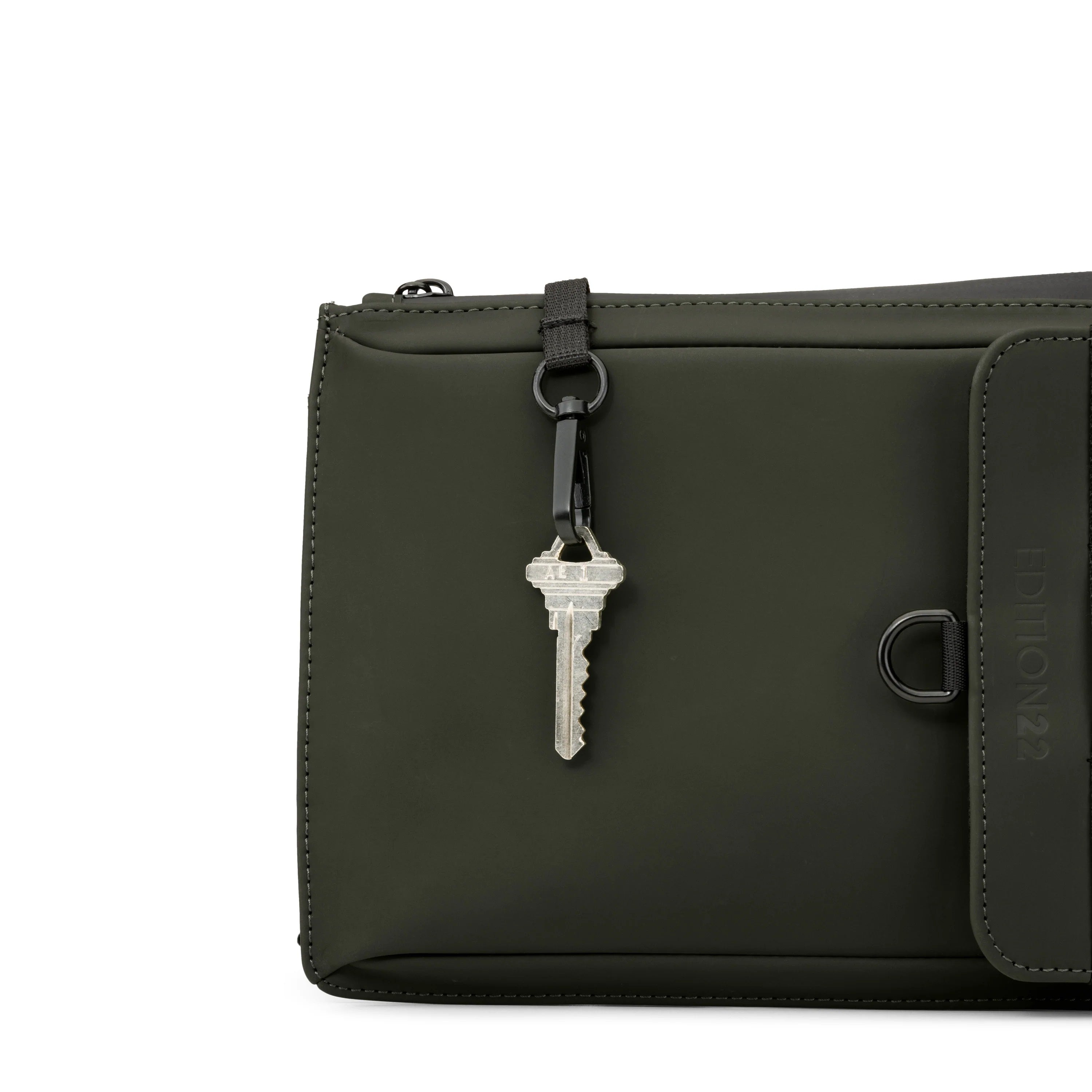 Dark green leather pouch with a key attached on a white background