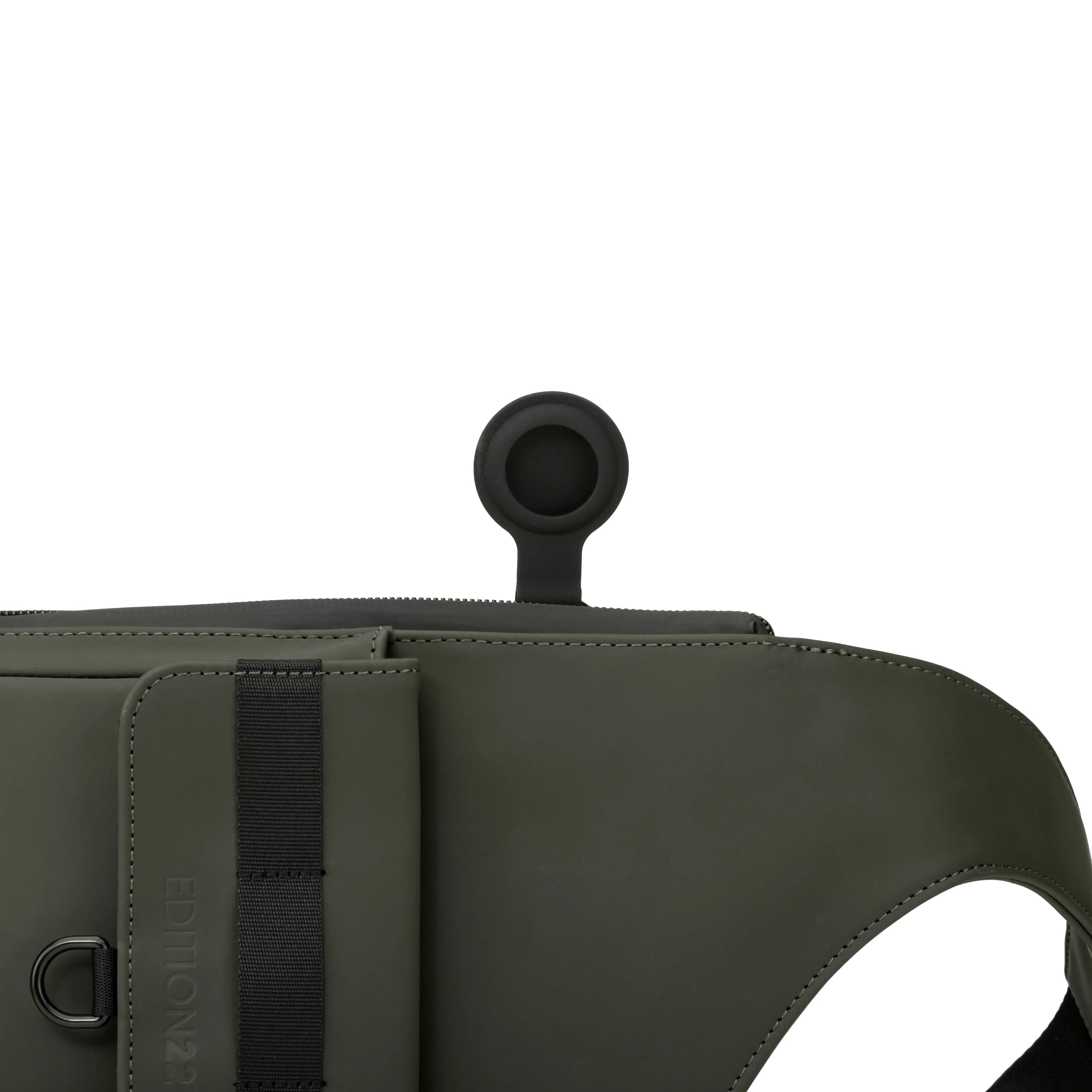 Green bag with black strap and circular handle on a white background