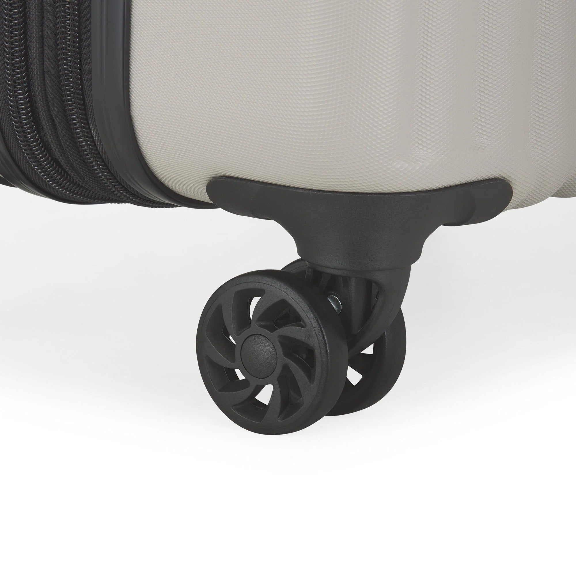 Close-up of a suitcase wheel on a light gray background