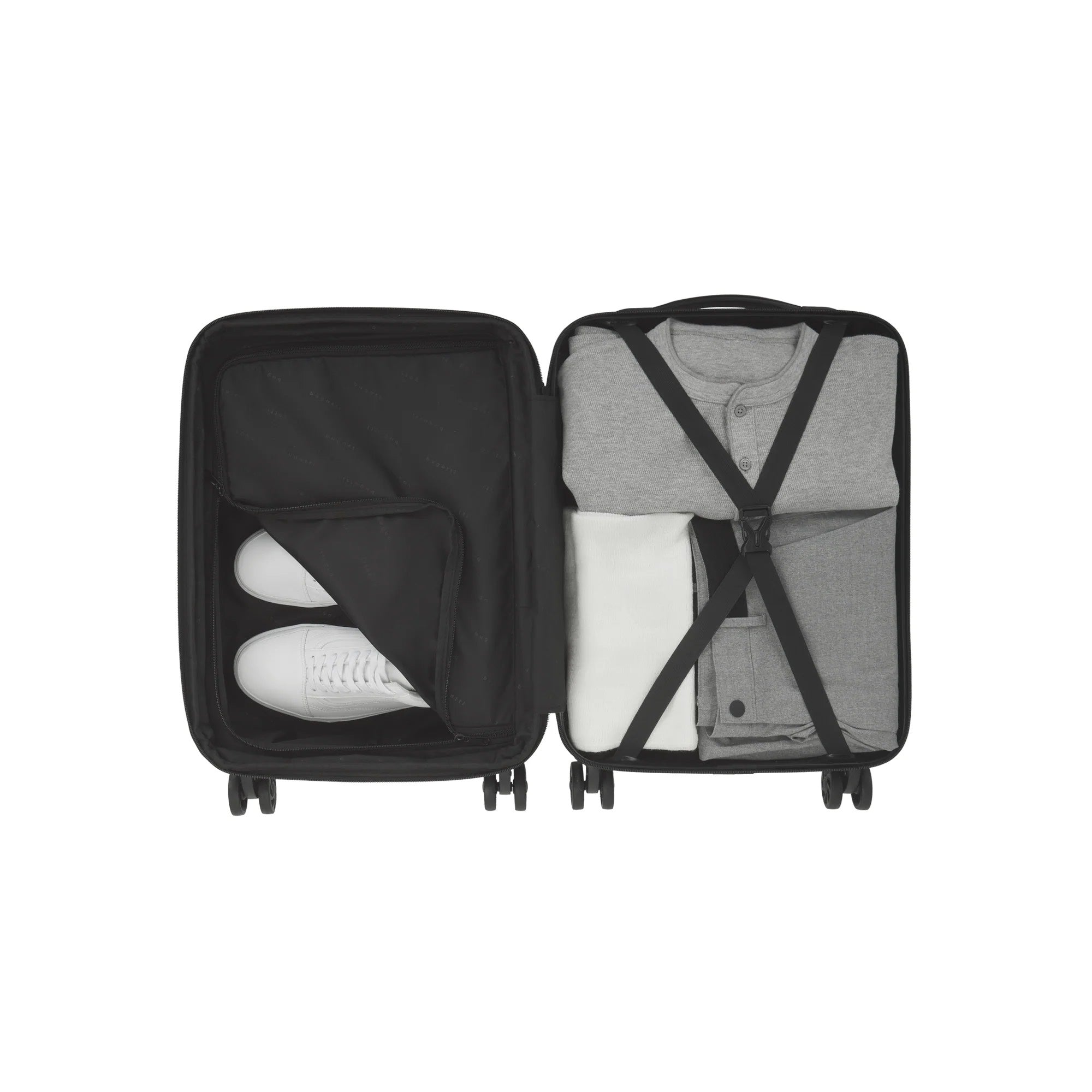Black suitcase with clothes and shoes on a white background