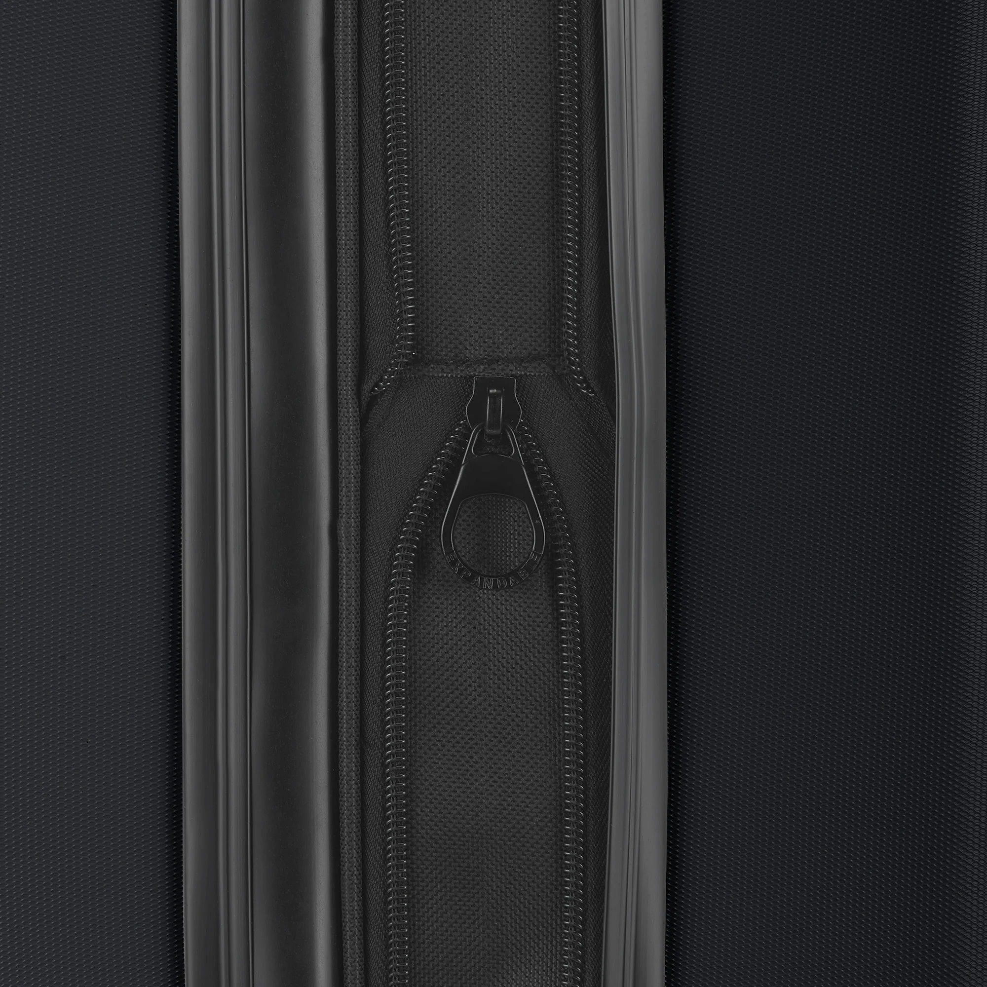 Close-up of a black zipper on a black suitcase