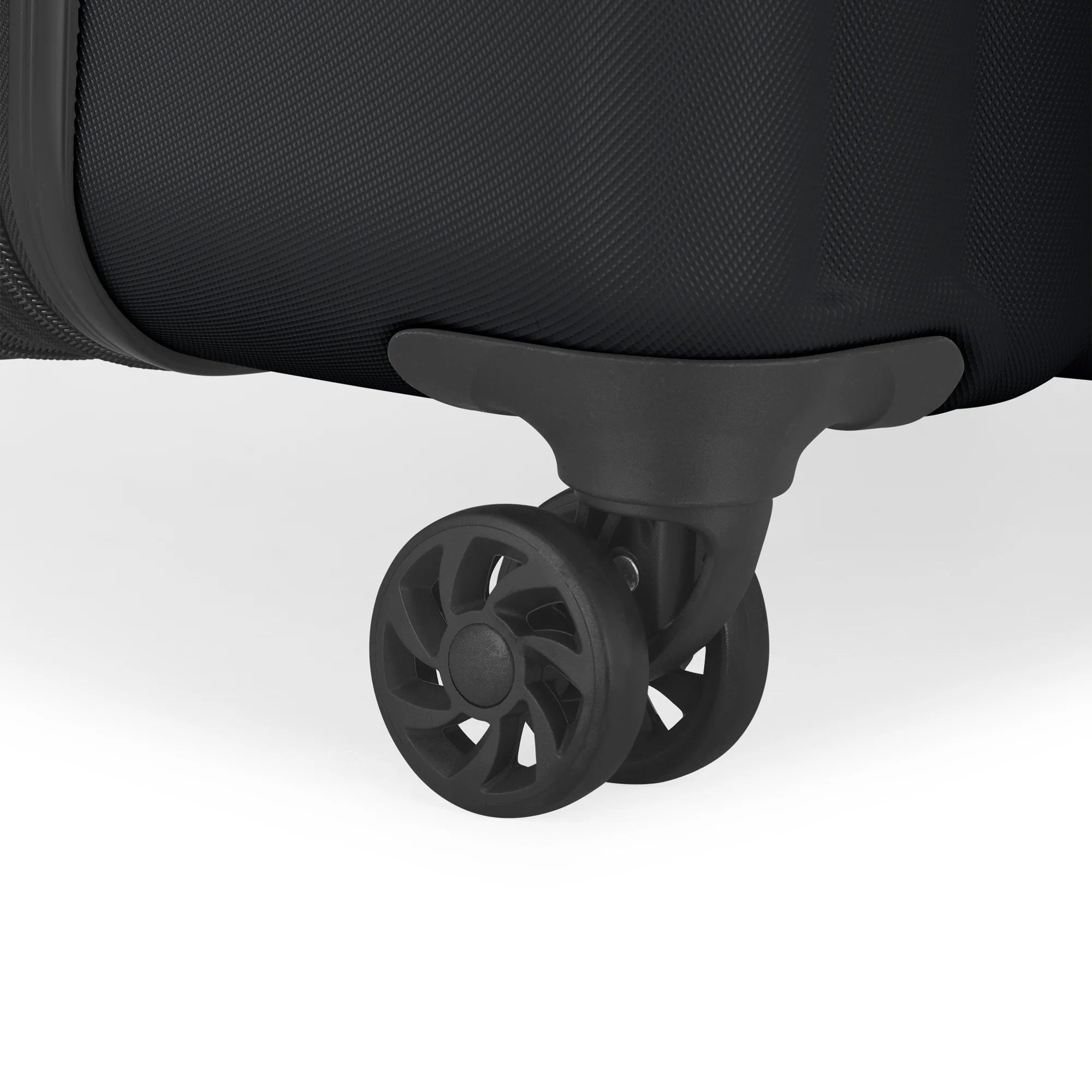 Close-up of a black suitcase wheel on a white background