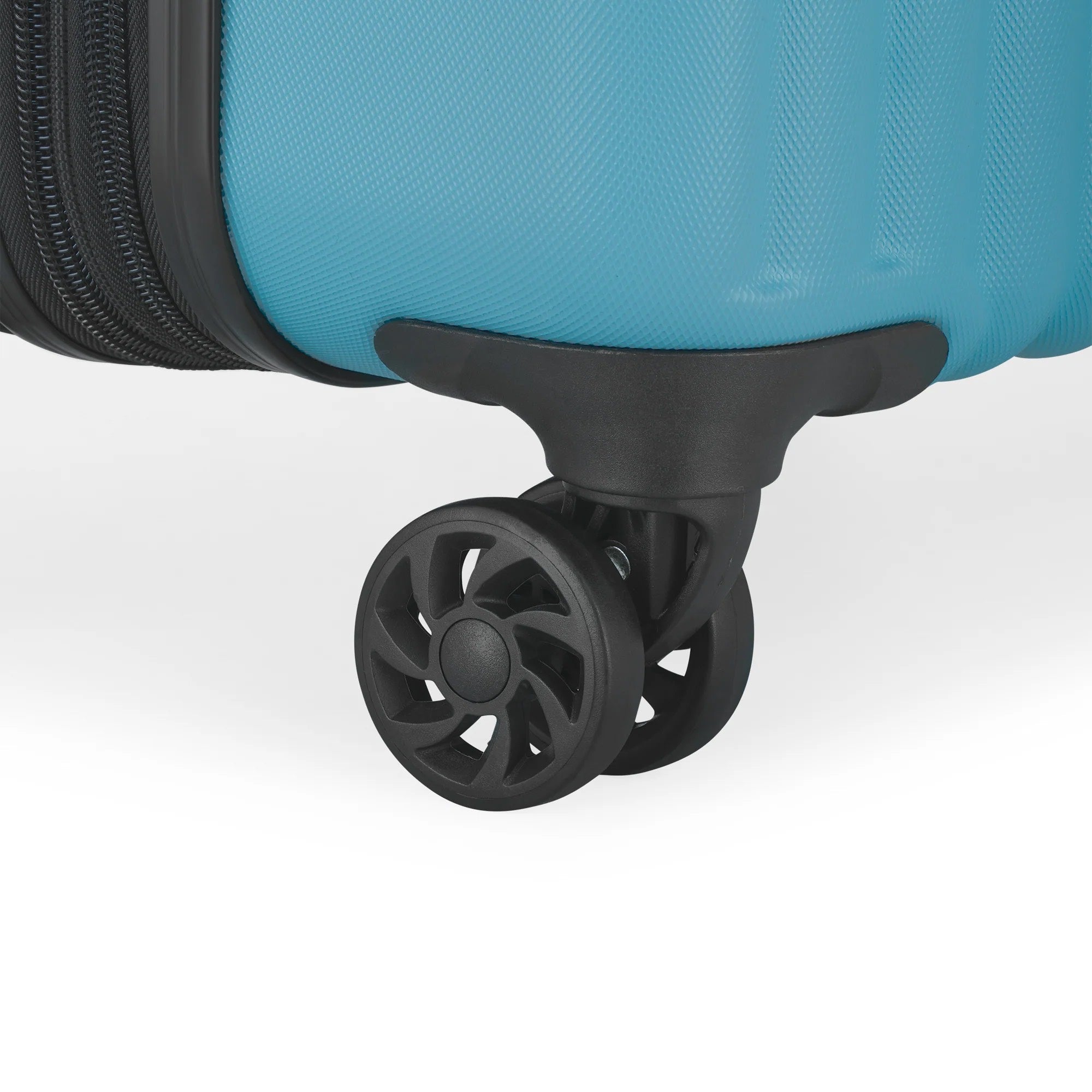 Close-up of a blue suitcase wheel on a white background