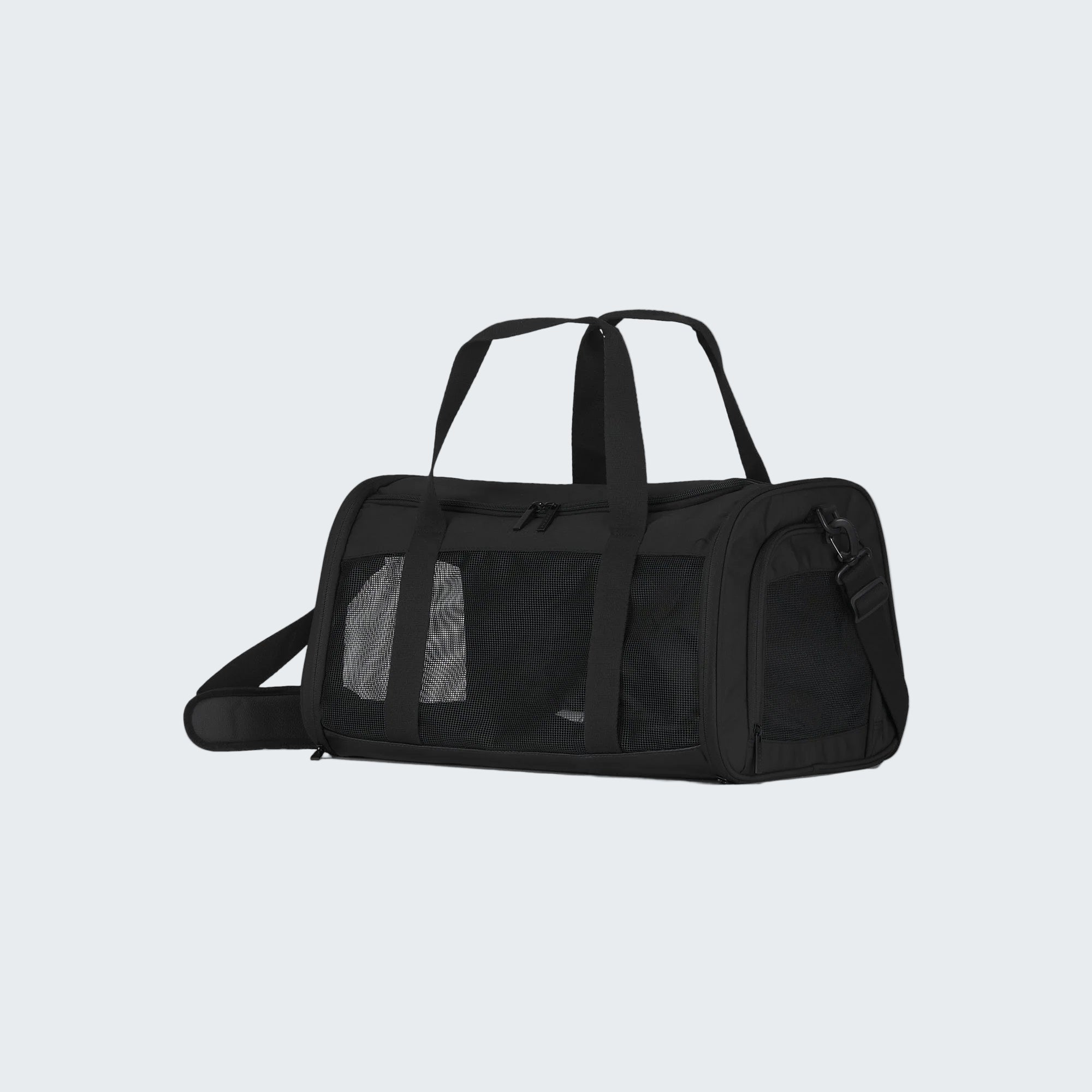 Black pet carrier with mesh sides on a white background
