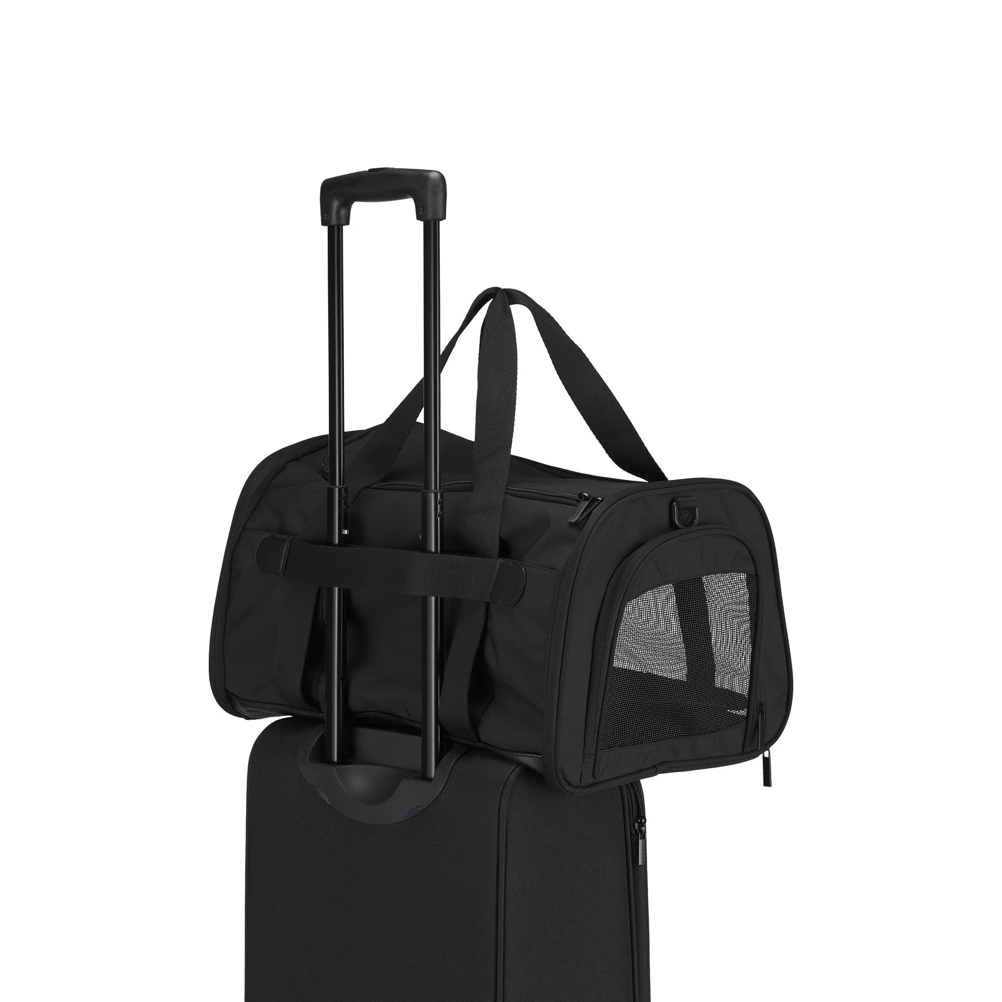 Black pet carrier attached to a suitcase on a white background