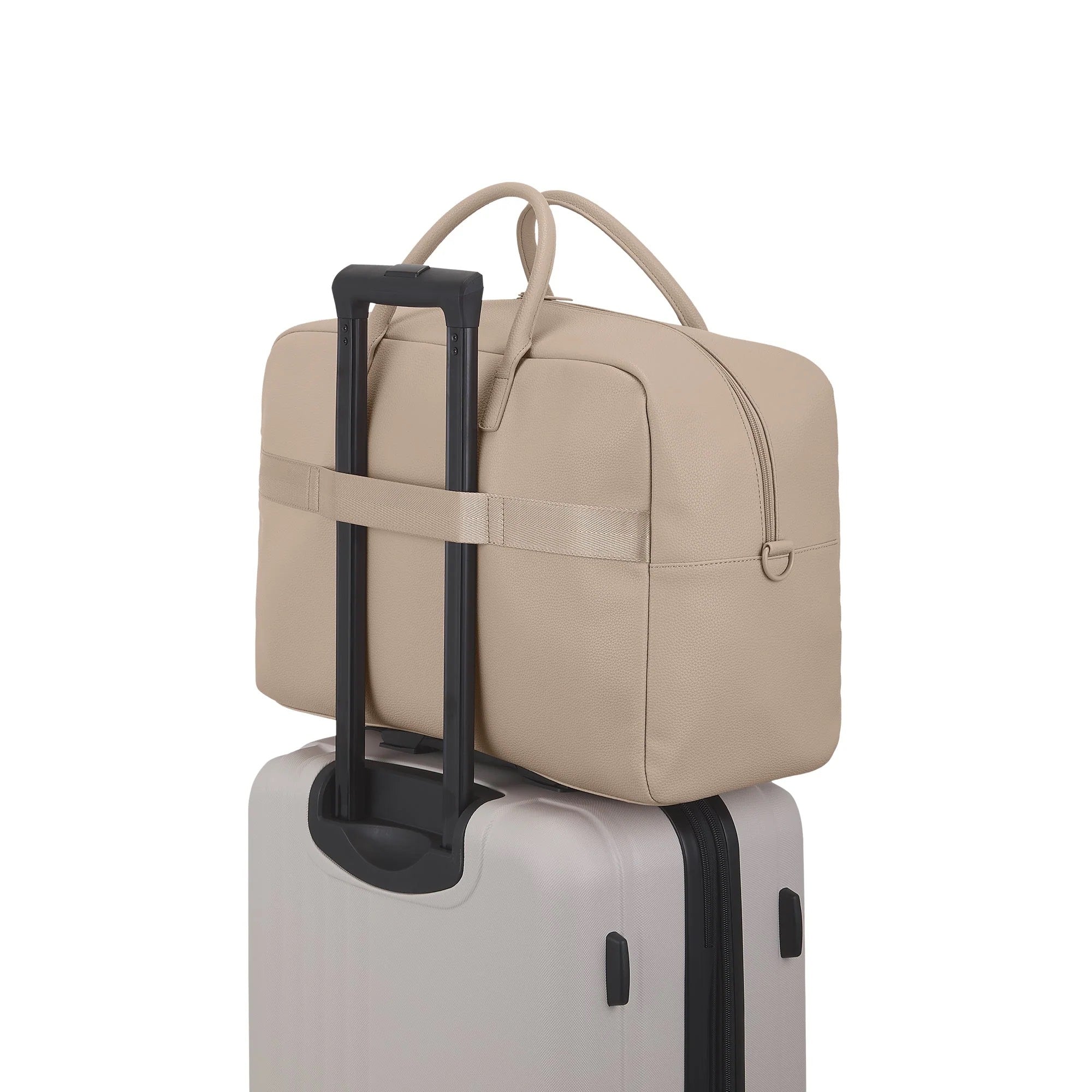 Beige travel bag with handle on top of a suitcase on a white background