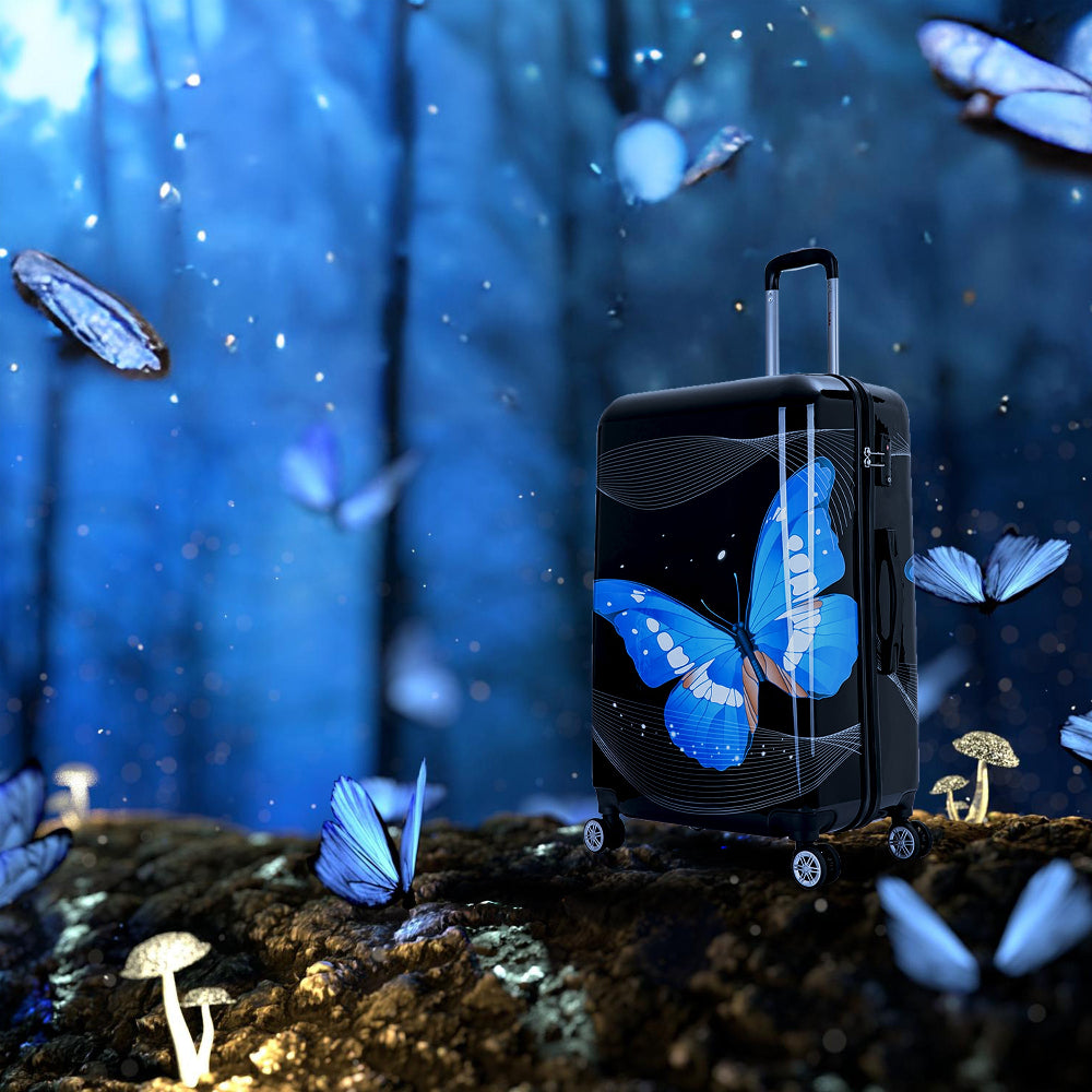 Black suitcase with blue butterfly design on a mystical forest background