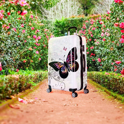 Suitcase with butterfly design in a garden setting