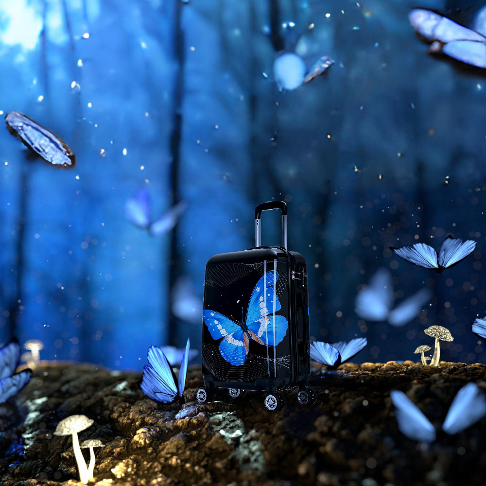 Black suitcase with butterfly design in a mystical forest setting