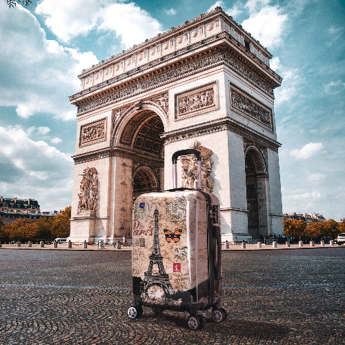 Suitcase with Eiffel Tower design in front of the Arc de Triomphe