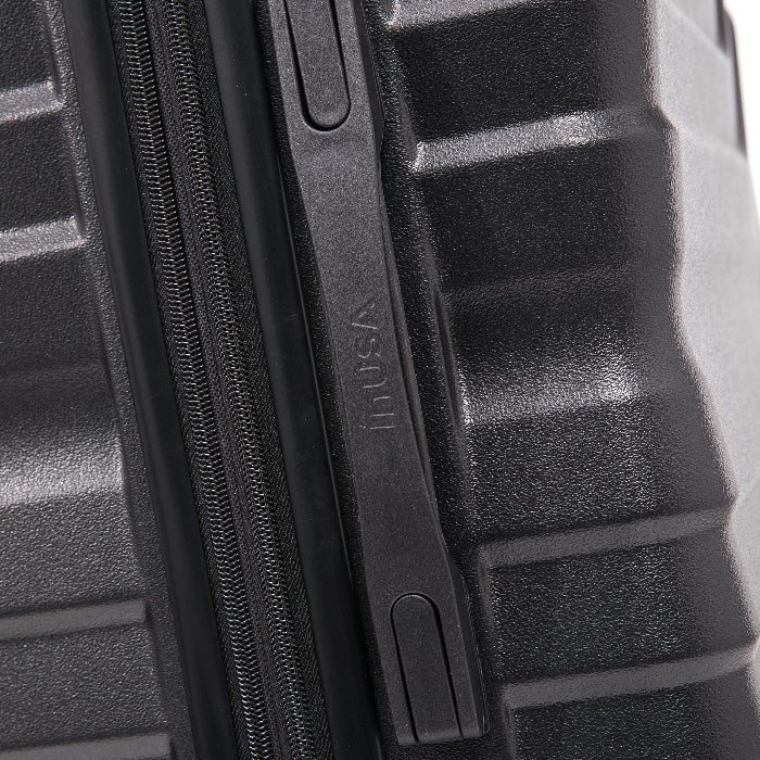 Close-up of a textured black suitcase with a zipper, featuring the brand 'Husa'.