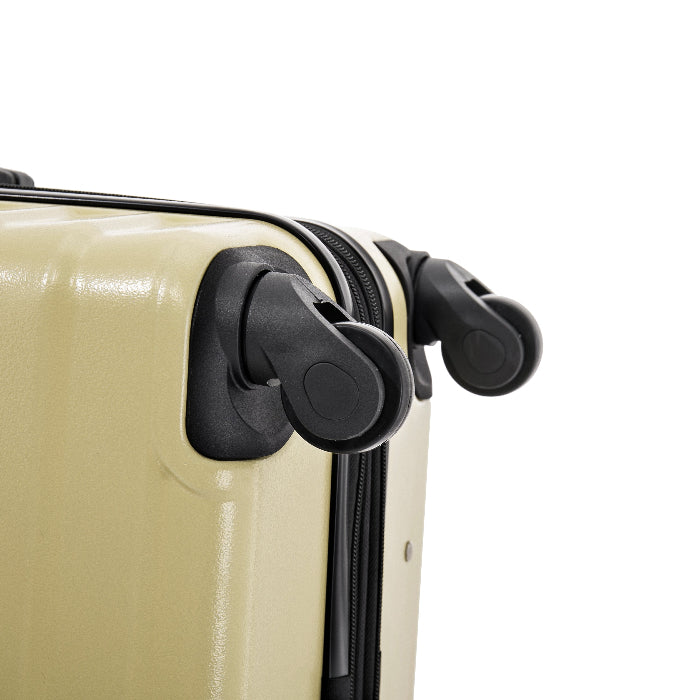 Close-up of a beige suitcase with black wheels on a white background