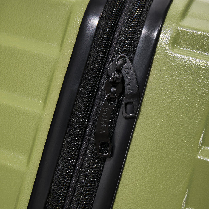 Close-up of a green suitcase with a black zipper, featuring the brand 'Itusa'.