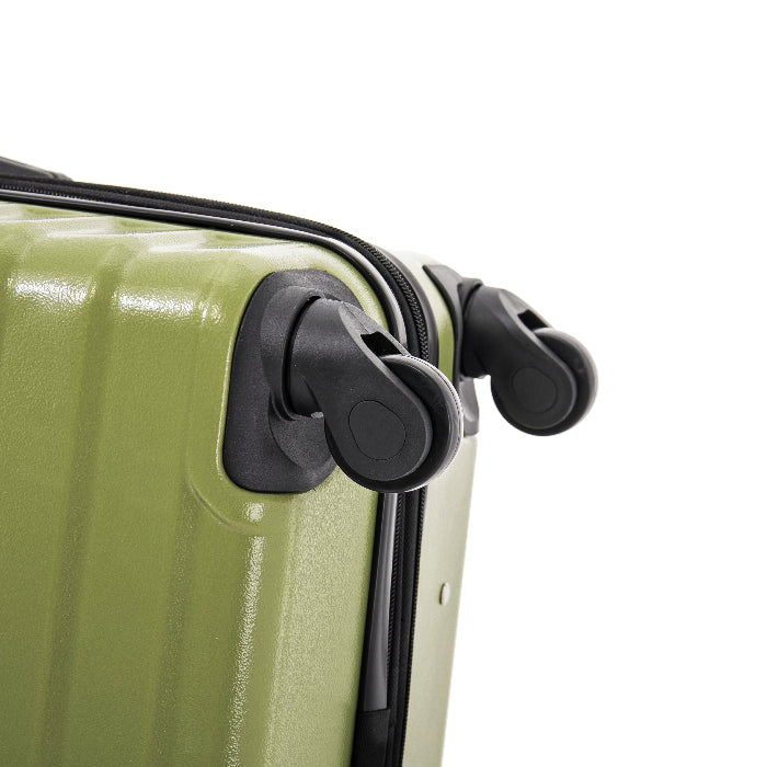 Close-up of a green suitcase with black wheels on a white background