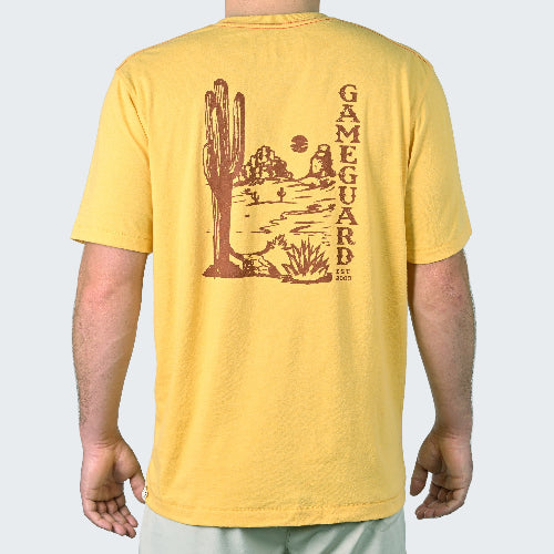 Yellow t-shirt with a cactus and desert landscape graphic on the back, worn by a person.